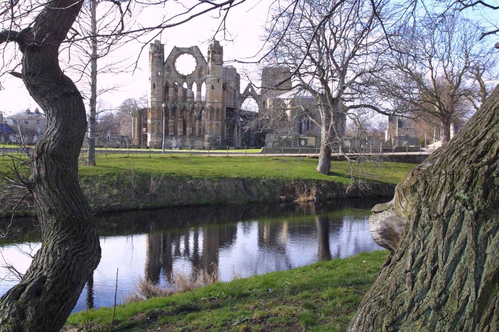 A view of Elgin Cathedral with the River Lossie in the foreground.