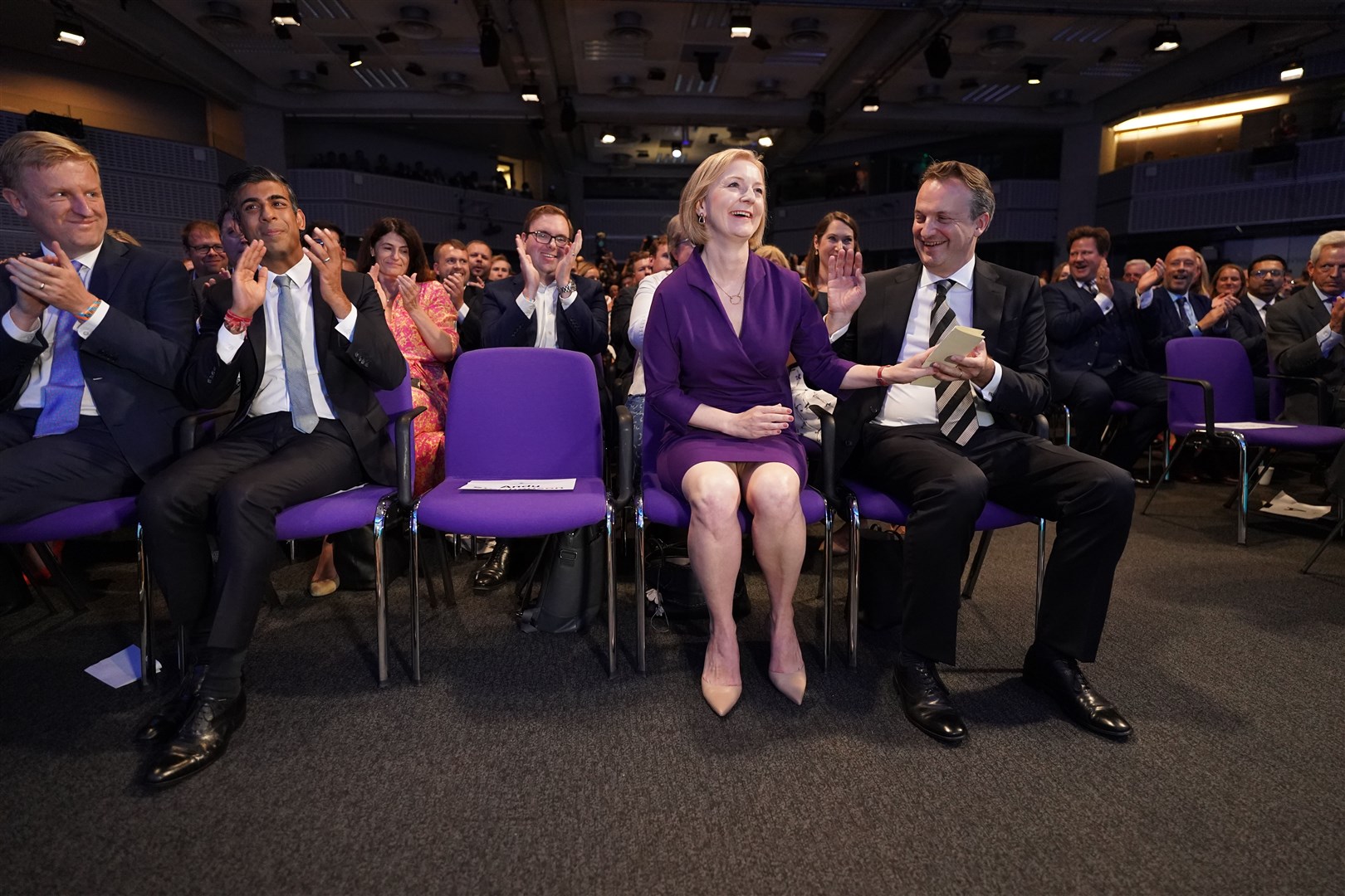 Left to right, Oliver Dowden, Rishi Sunak, Liz Truss, and her husband Hugh O’Leary, at the Queen Elizabeth II Centre in London as it was announced that Ms Truss is the new Conservative Party leader and will become the next prime minister (Stefan Rousseau/PA)