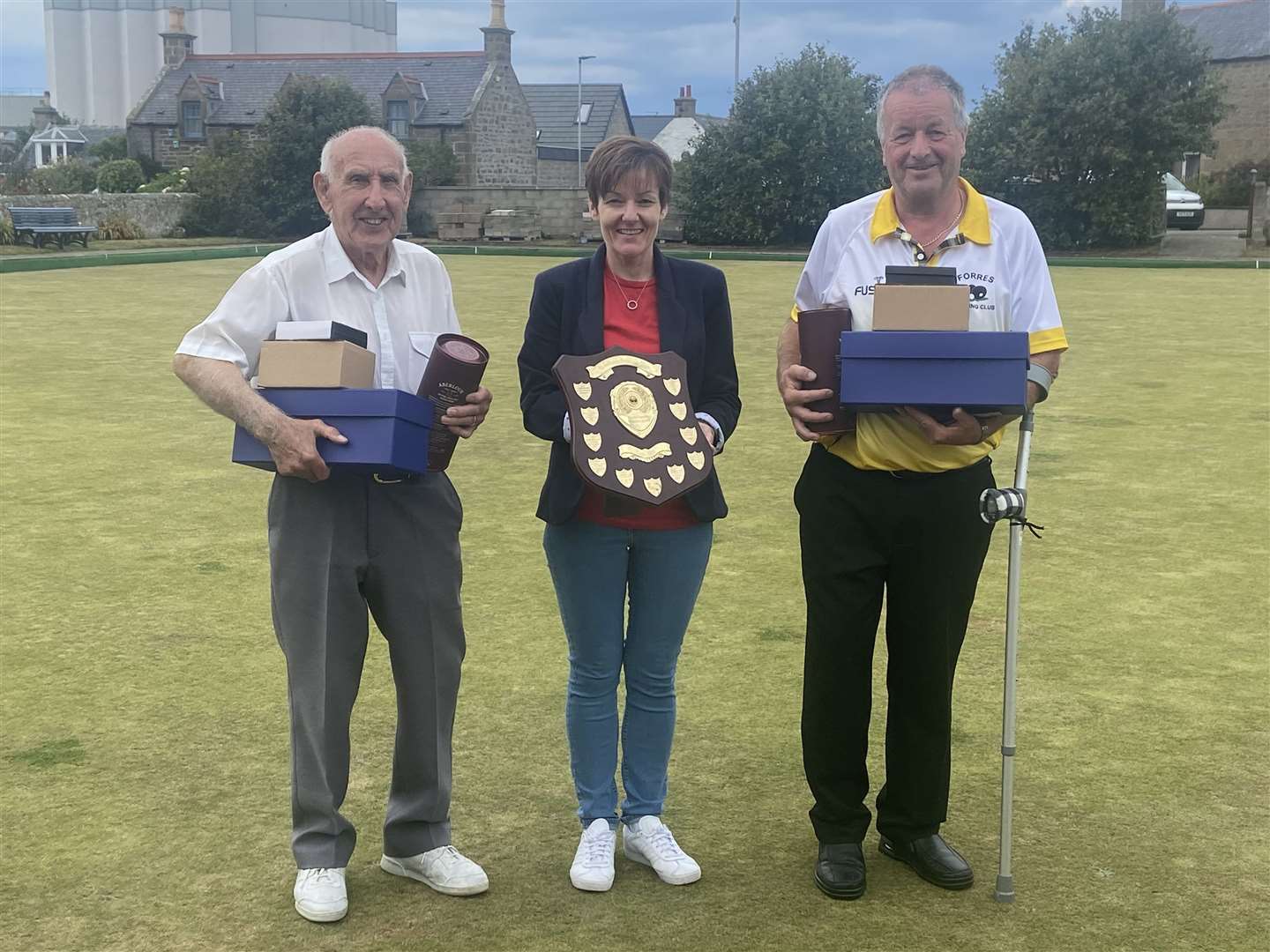Audrey Christie presents the trophy in her father Murray Cormie's memory to winning Forres Bowling Club duo Stuart Robertson (left) and John Ross at St Aethan's Bowling Club in Burghead.