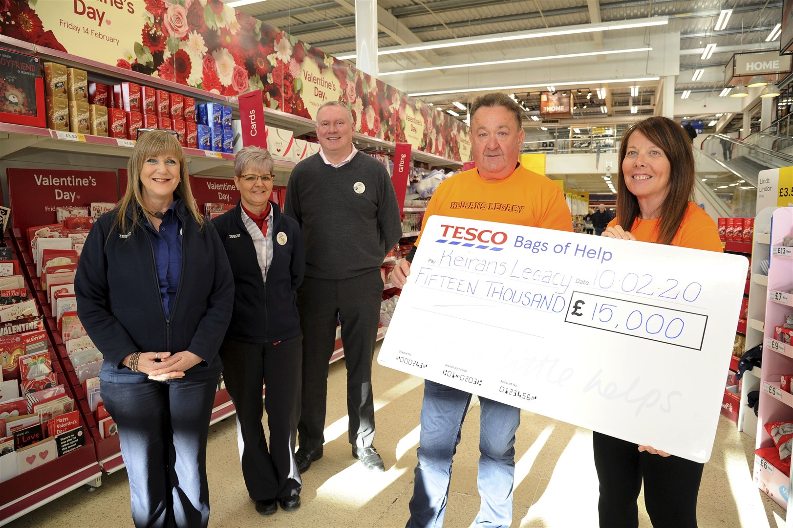 Sandra and Gordon McKandie, of Keiran's Legacy, receive a cheque for £15,000 from the Tesco Centenary Bags of Help scheme. Presenting the special prize at Elgin's Tesco were (from left) community champion Tracy Gourlay, service manager Debbie Mculloch and store manager Jonathon Merriman. Picture: Eric Cormack.