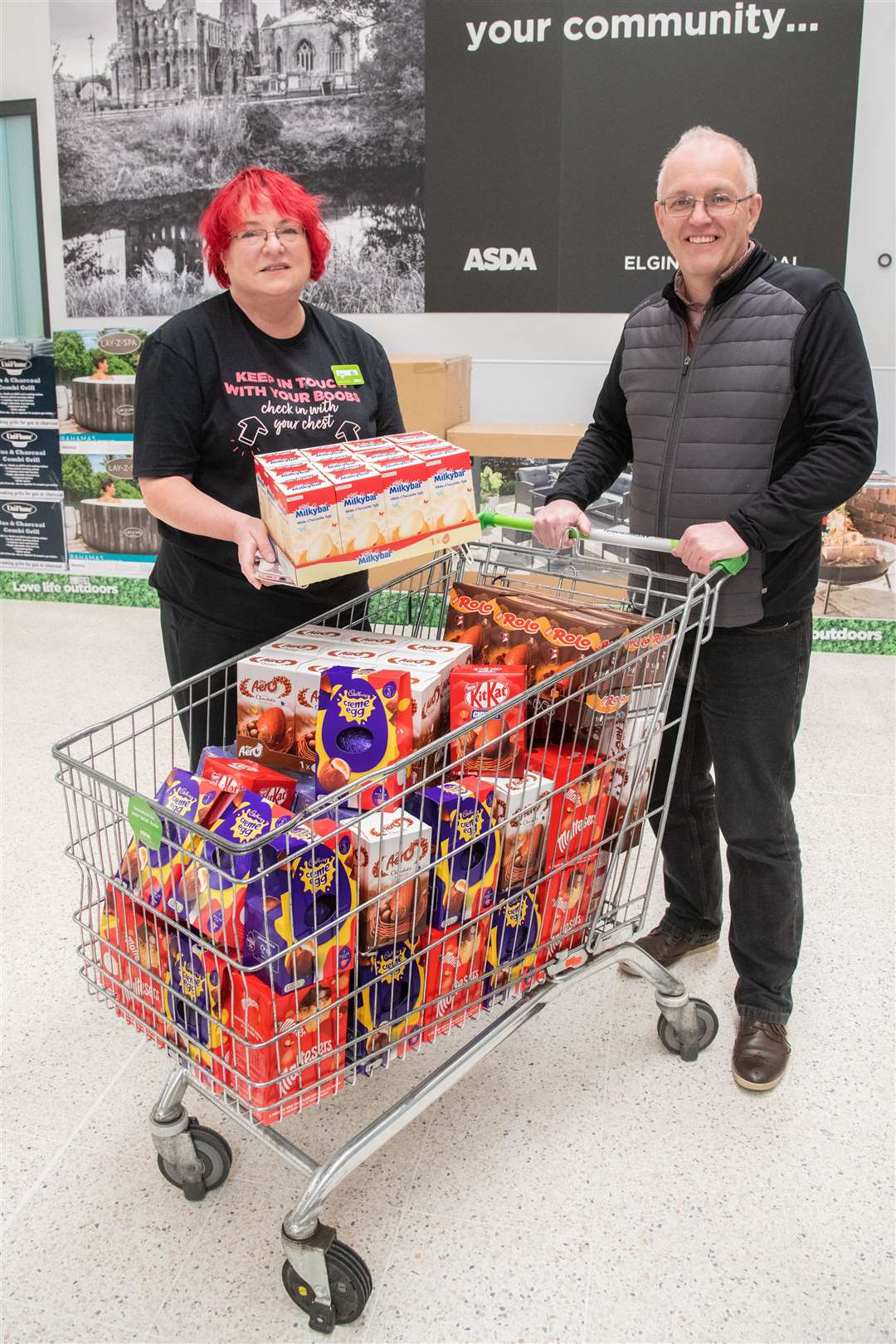 Asda Elgin community champion Irene Geddes with the donation to the Moray Easter Egg appeal collected by Chris Saunderson, joint content editor of The Northern Scot. Picture: Daniel Forsyth