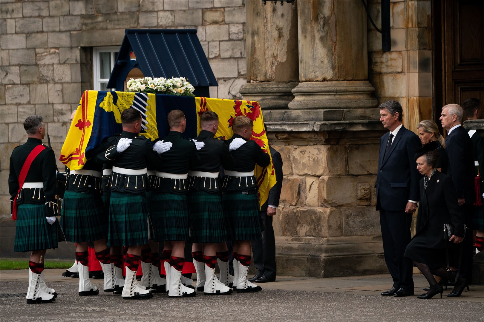 The Princess Royal curtseys to the Queen’s coffin as it arrives at the Palace of Holyroodhouse. Aaron Chown/PA