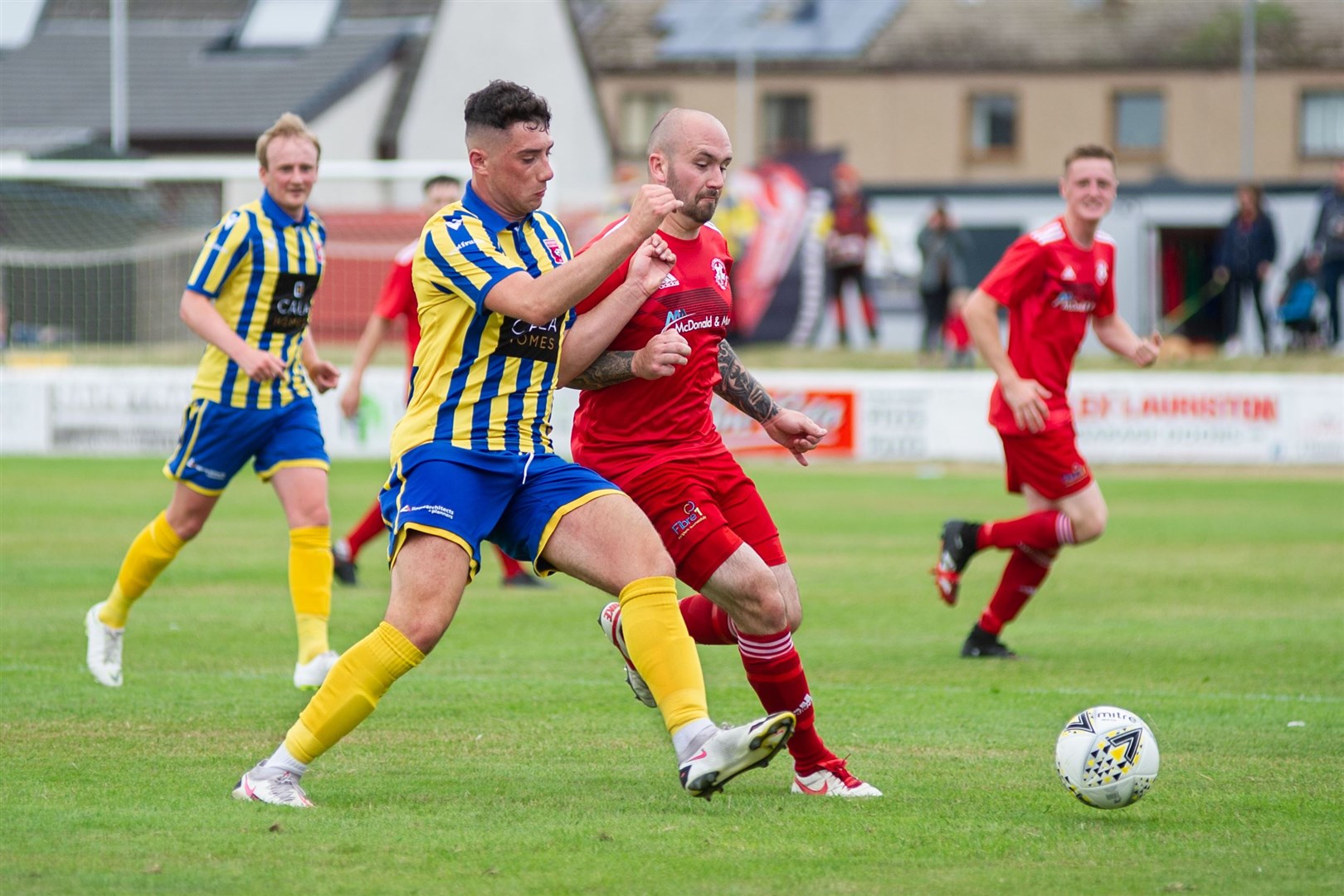Lossiemouth's Connor Macaulay and Locos Lloyd Robertson compete well for the ball. Picture: Daniel Forsyth..