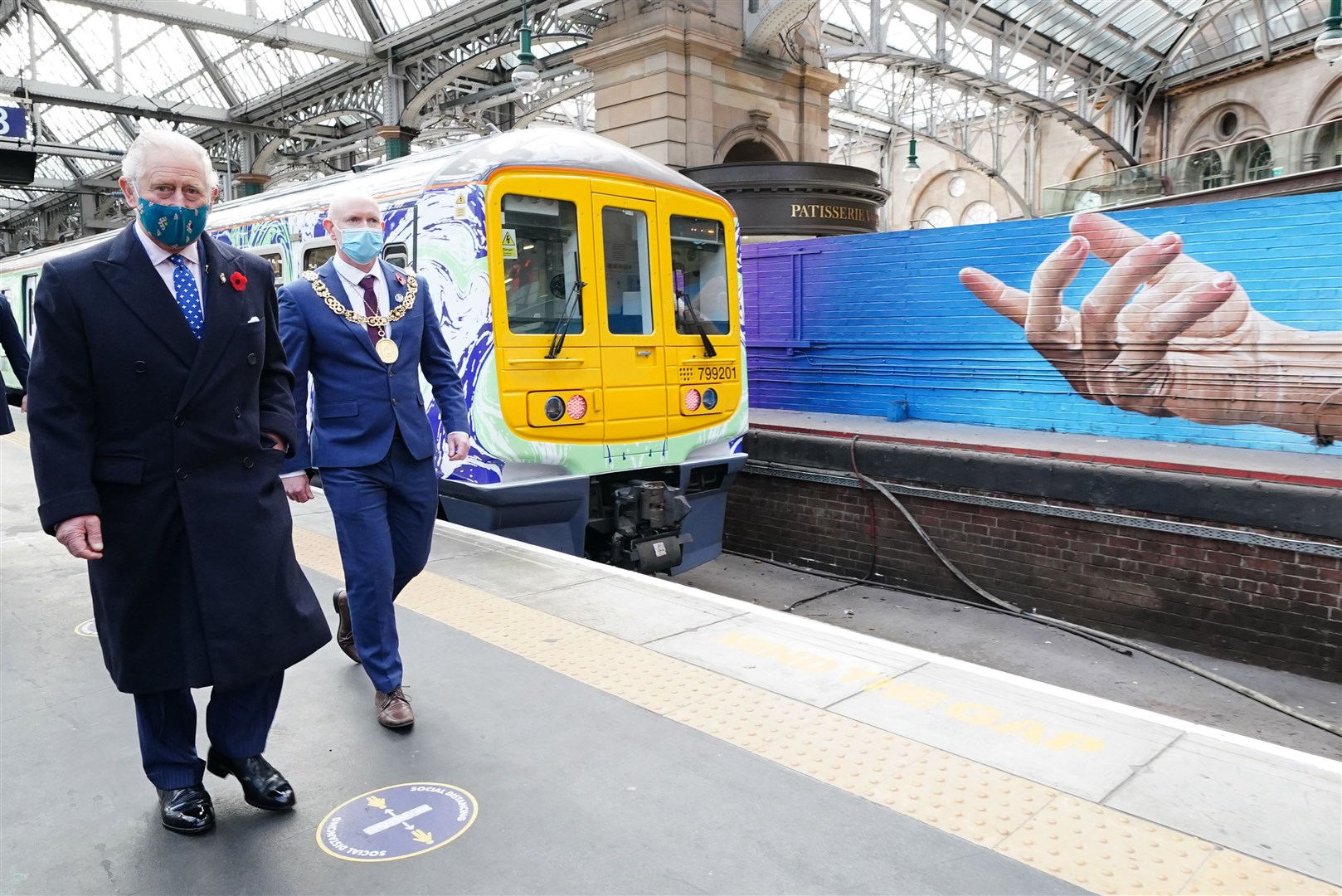 The Prince of Wales views the ‘green powered’ trains in Glasgow (Jane Barlow/PA)