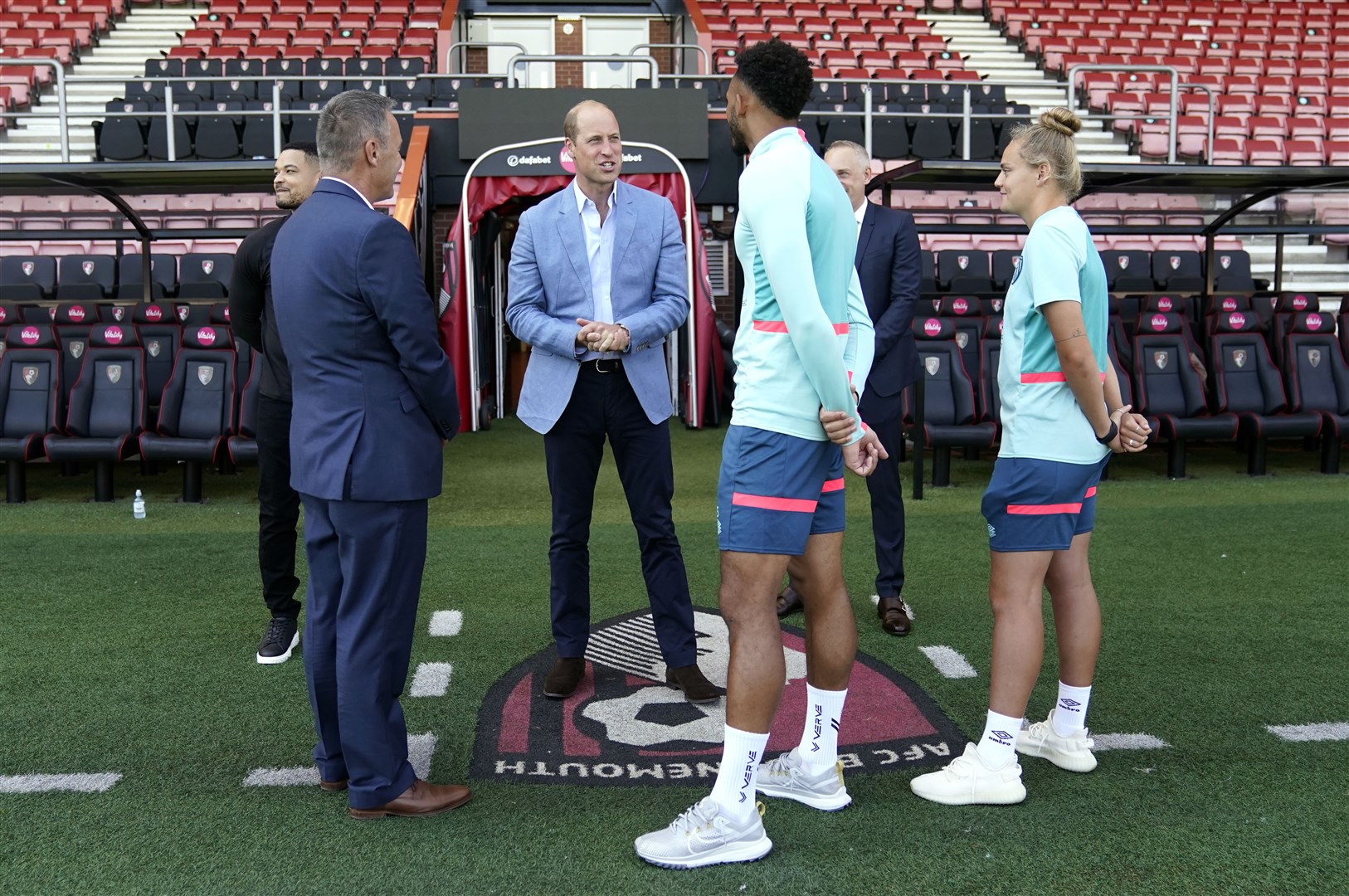 The Prince of Wales chats with AFC Bournemouth players Lloyd Kelly and Katie Scadding (Andrew Matthews/PA)