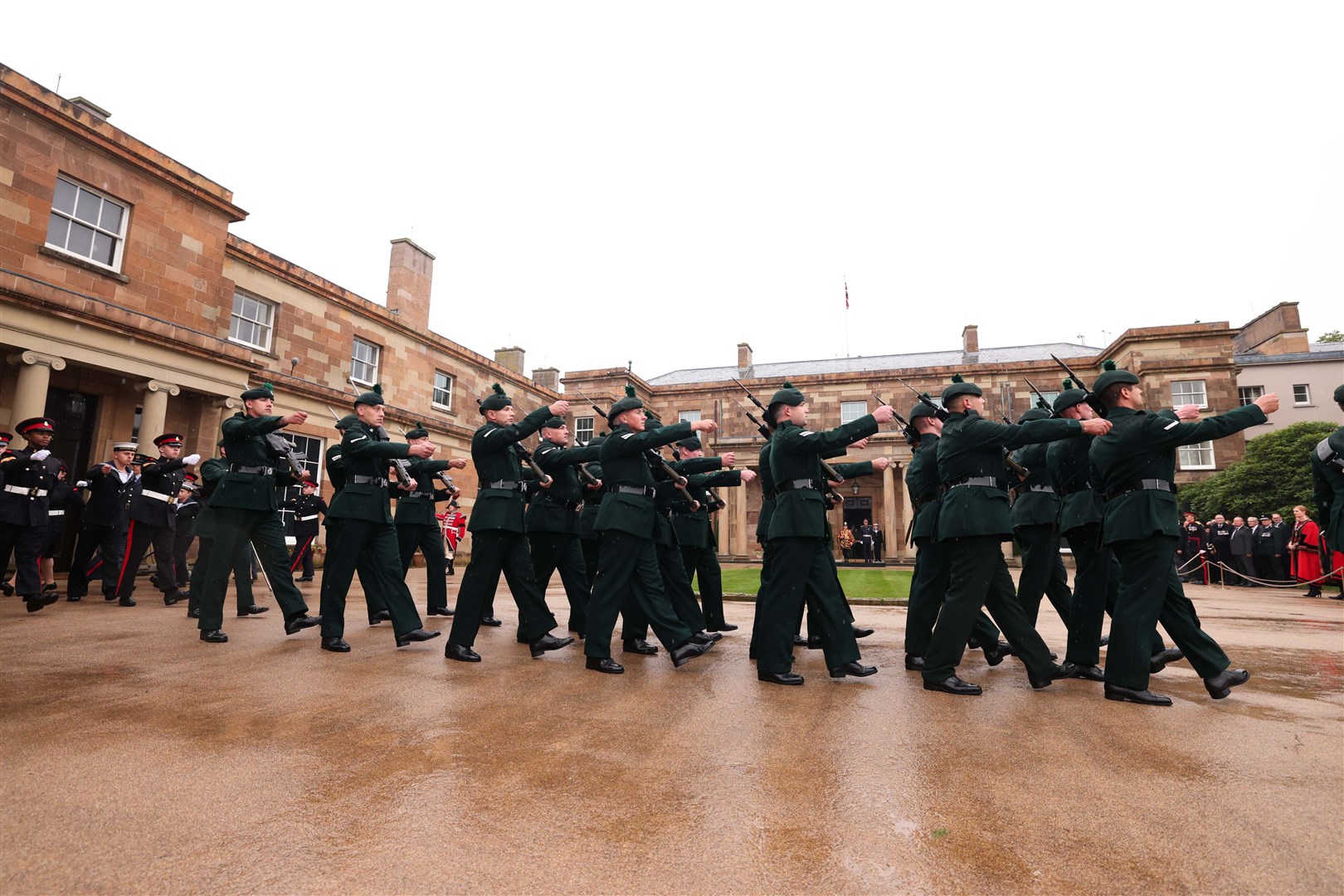 The rain fell throughout the ceremony at Hillsborough Castle (Kelvin Boyes/PA)