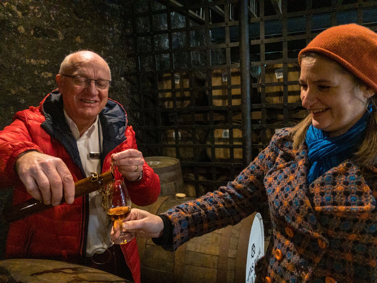 Distillery guide Mike Collins pours a dram for a visitor.