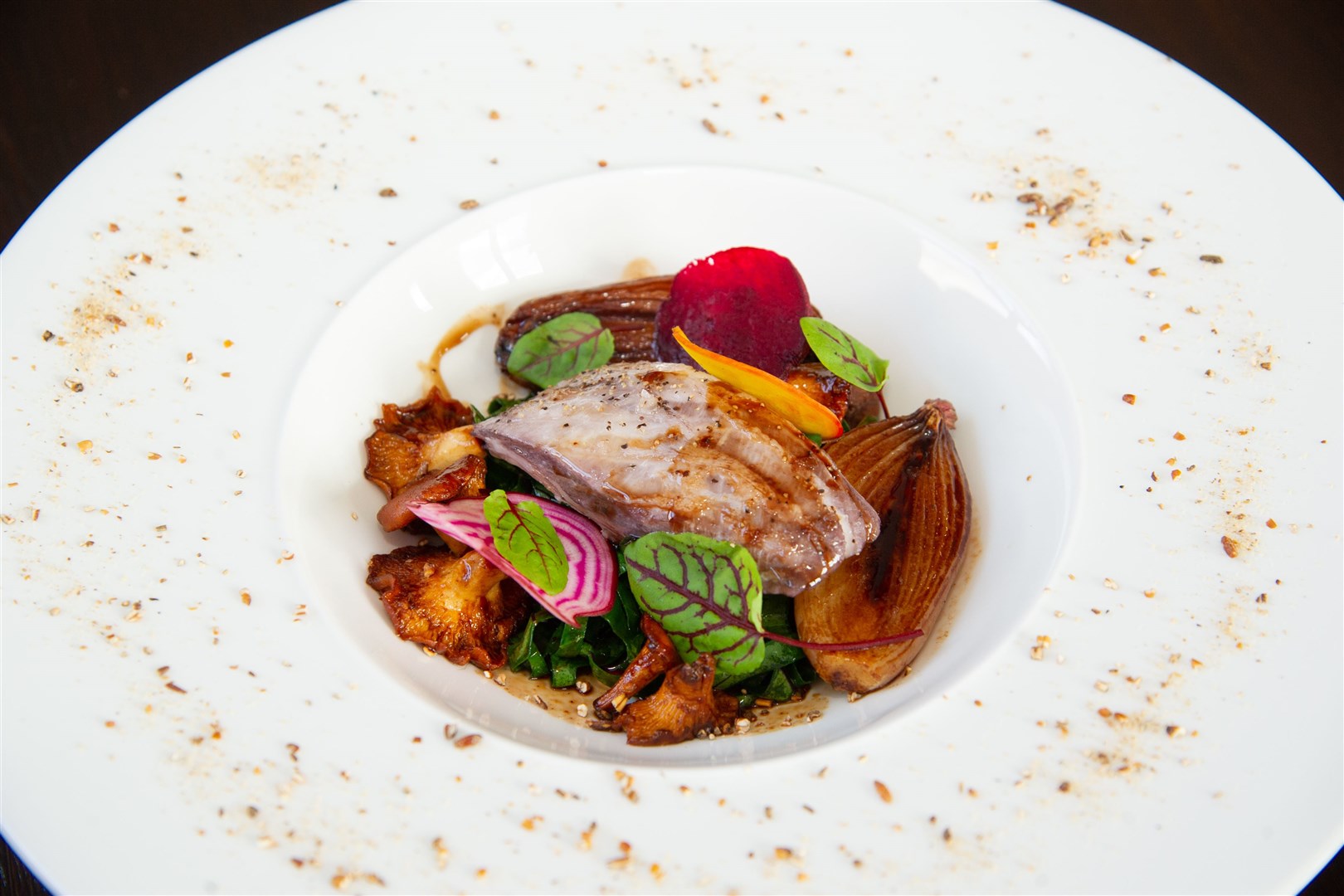 Halibut with early chanterelle mushrooms, shallot, beetroot, kohlrabi leaf and veal jus. Picture: Daniel Forsyth.