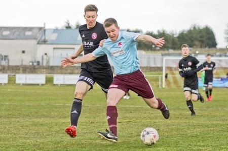 Keith's Ryan Spink holds off Brora's Martin McLean in Saturday's League Cup quarter-final. Picture: Daniel Forsyth. Image No.040632