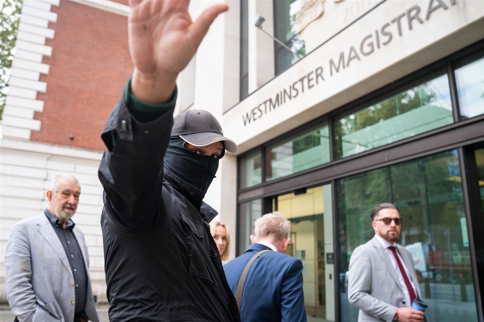 Metropolitan Police officer Thomas Phillips, with his face covered, arrives at Westminster Magistrates’ Court for sentencing (James Manning/PA)