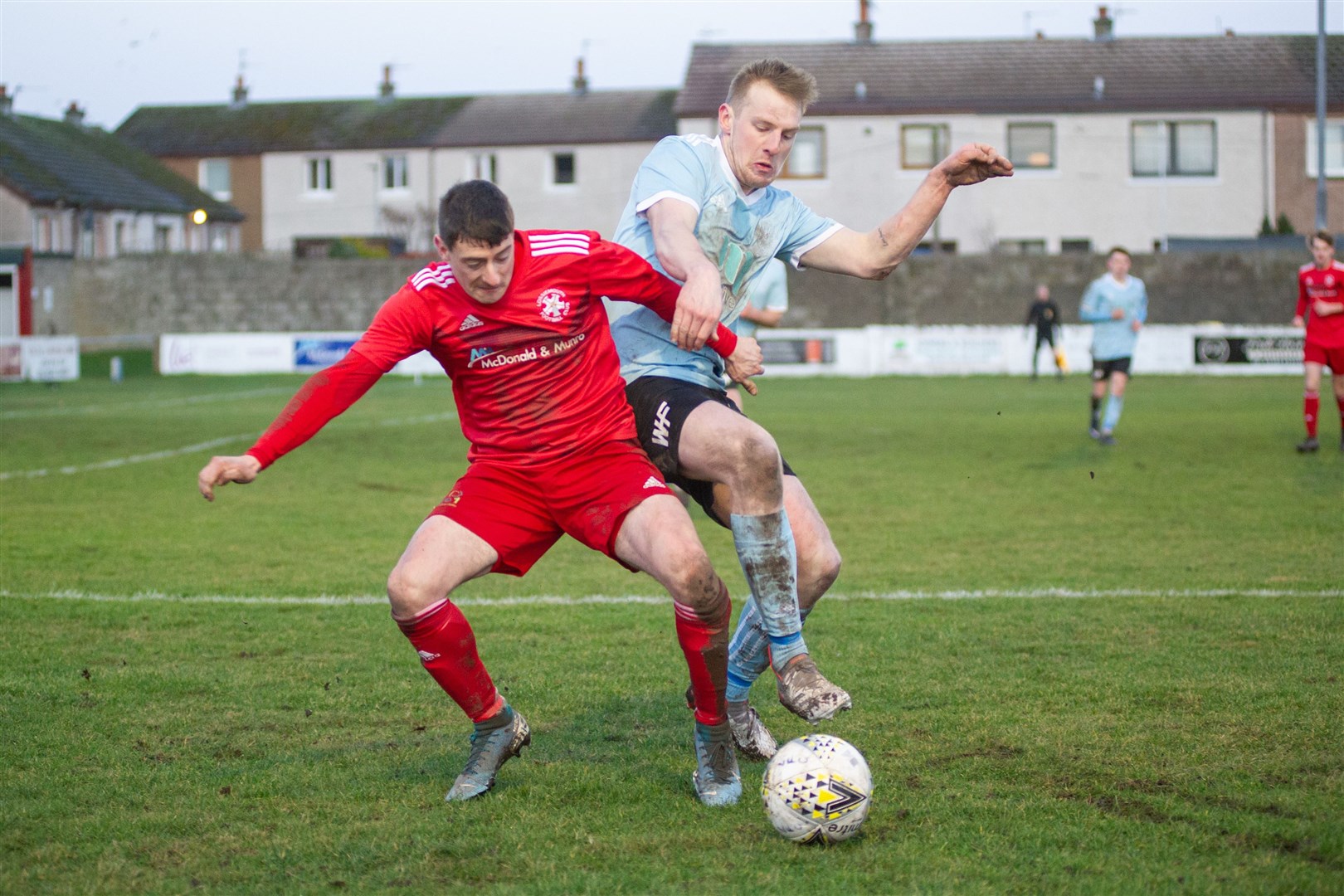 Coasters forward Ross Archibald tussles with Deveronvale full back Aaron Hamilton...Lossiemouth FC (2) vs Deveronvale FC (1) - Highland Football League - Grant Park, Lossimouth 05/02/2022...Picture: Daniel Forsyth..
