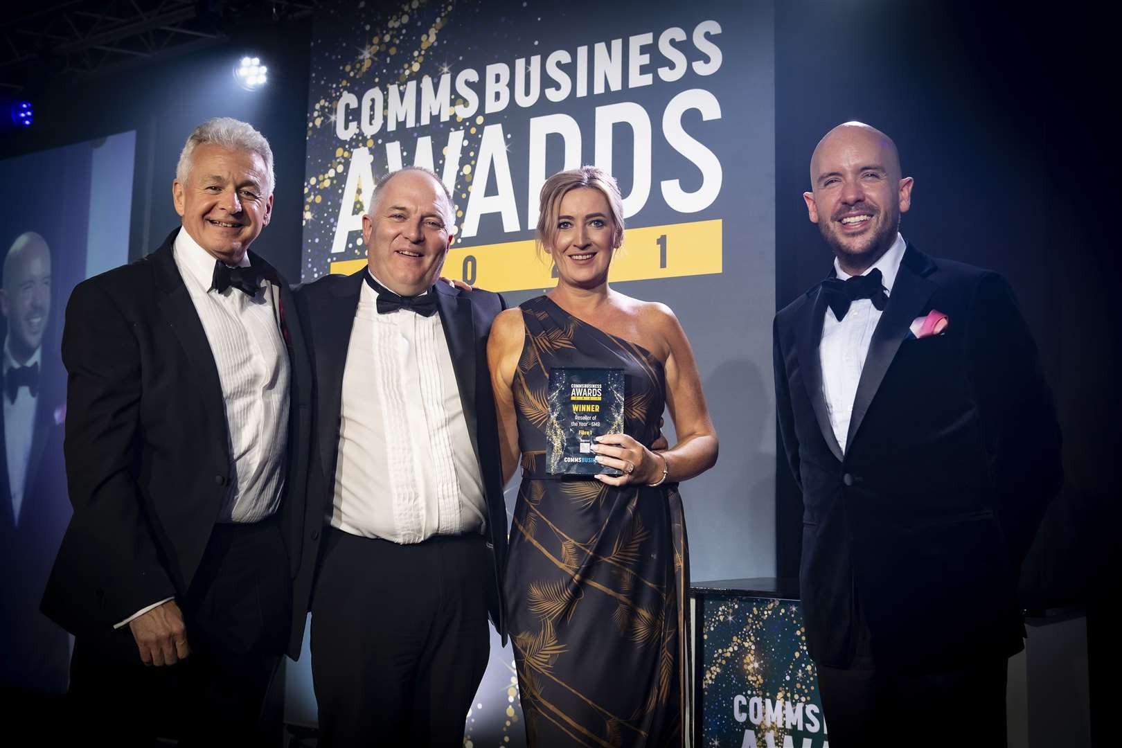 Garry Growns of event sponsor Digital Wholesale Solutions, Fibre 1’s Stewart Macdonald and Lynn Stewart, and comedian Tom Allen at the awards ceremony.