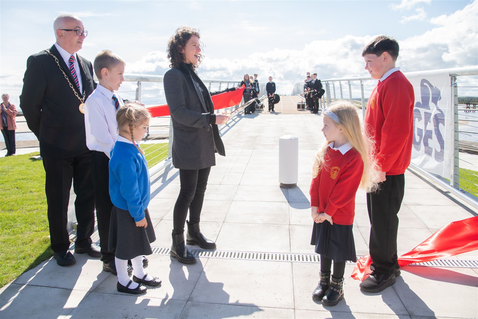 Cabinet Secretary Mairi Gougeon cuts the ribbon with the help of Hythehill pupils Jordan Muir and Ruby Watts (left), St Gerardine pupils Aiden Ingram and Lola Thomson, watched by Moray Council Convener Cllr Marc Macrae. Picture: Daniel Forsyth