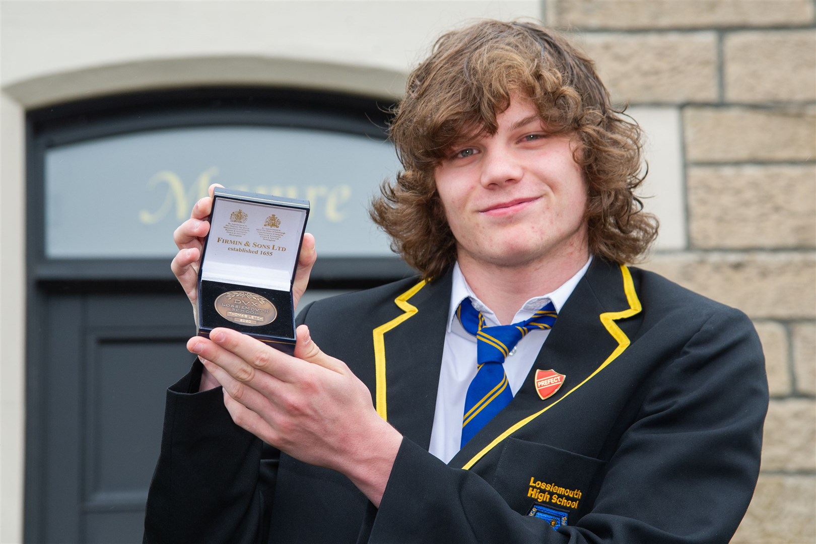 Lossiemouth High School dux Thomas Letch receives his accolade at home in Lossiemouth ahead of the school's virtual award ceremony. Picture: Daniel Forsyth.
