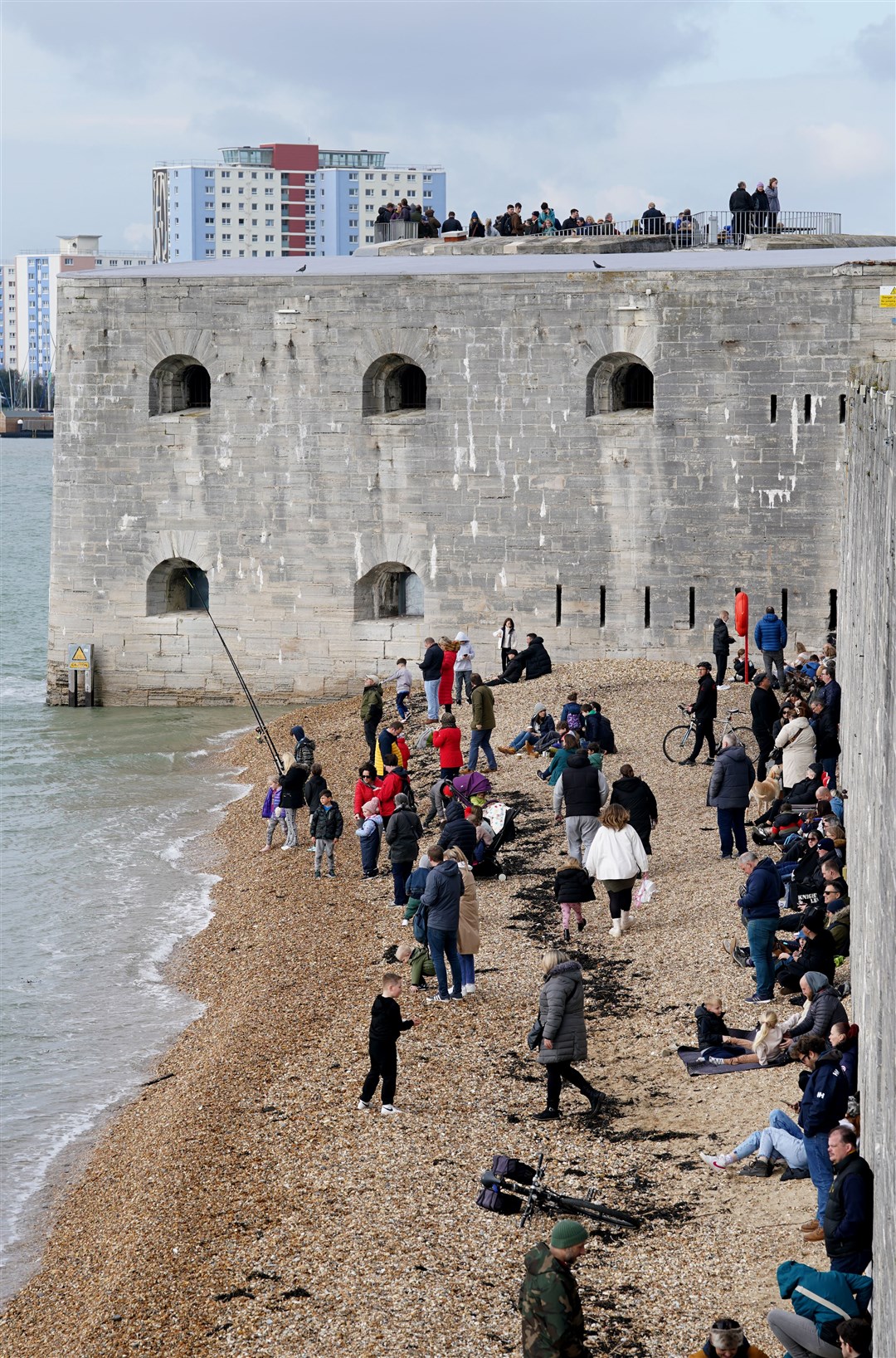 Spectators gather near Portsmouth Harbour to see the Royal Navy aircraft carrier HMS Prince of Wales before the sailing was cancelled (Gareth Fuller/PA)