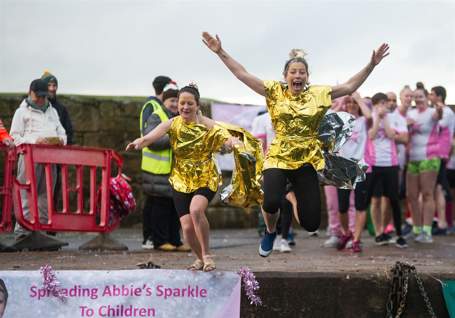 Chelle Parker and Kate Mackay take the leap at last year's Burghead Boxing Day Swim. Picture: Becky Saunderson.