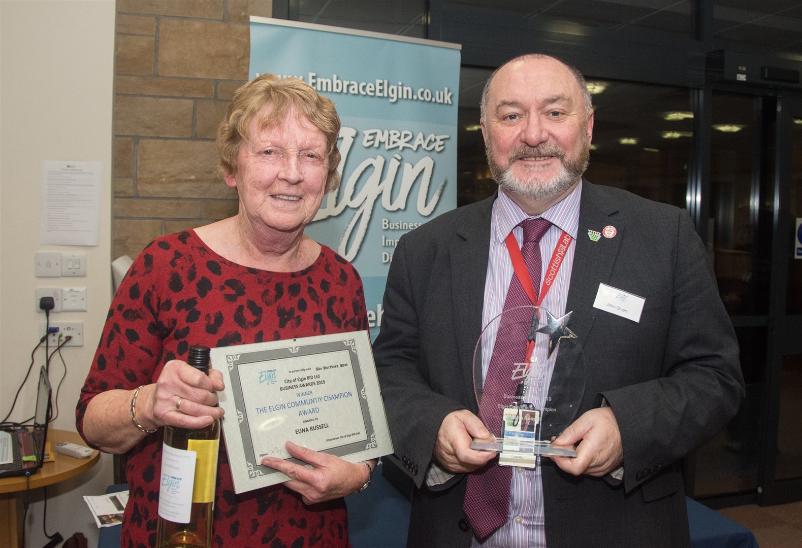 Councillor John Divers hands over the Elgin Community Champion award to Euna Russell.