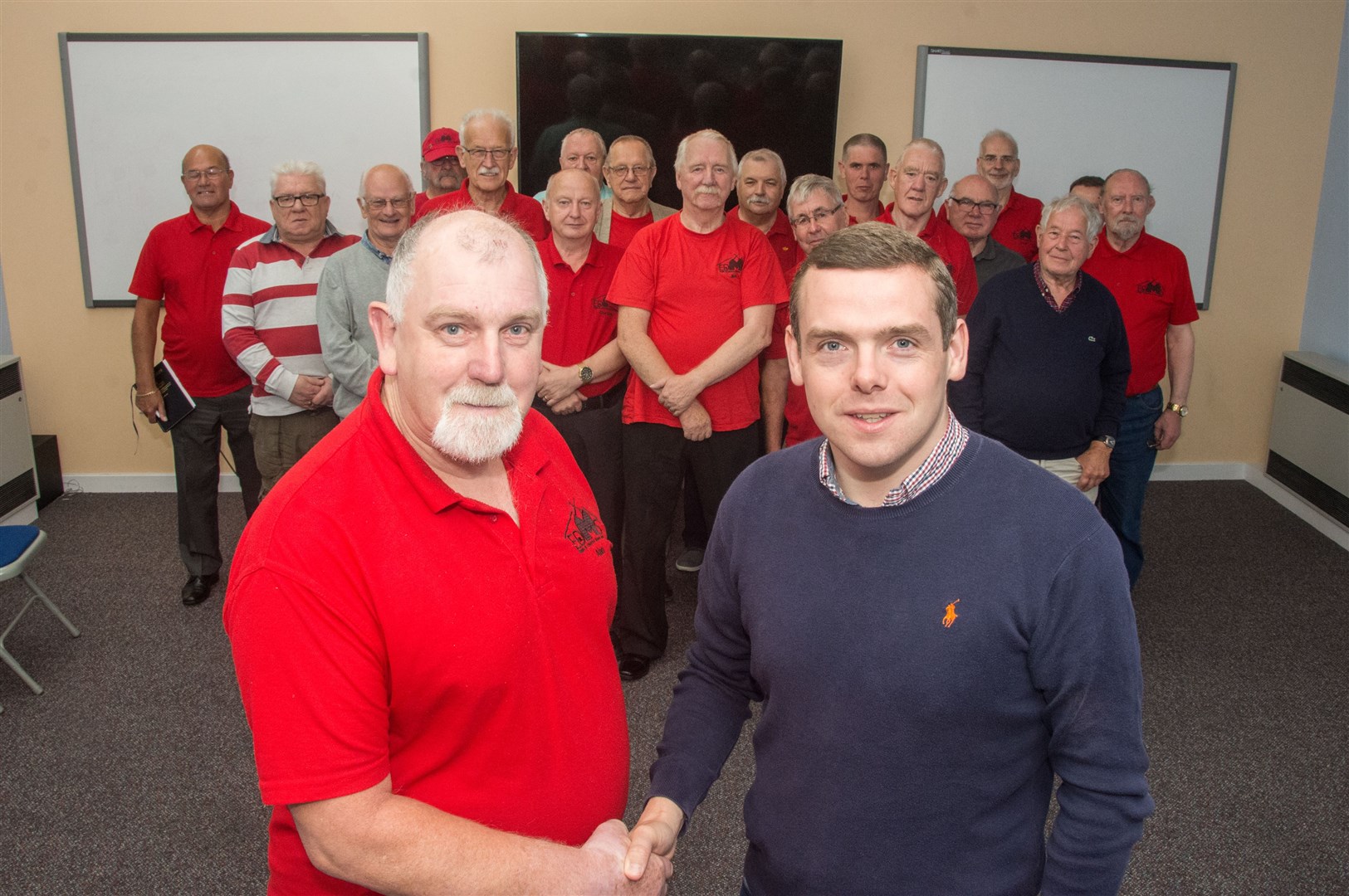 Moray MP Douglas Ross (right) with Elgin and District Men's Shed chairman Alan Baillie and other members.