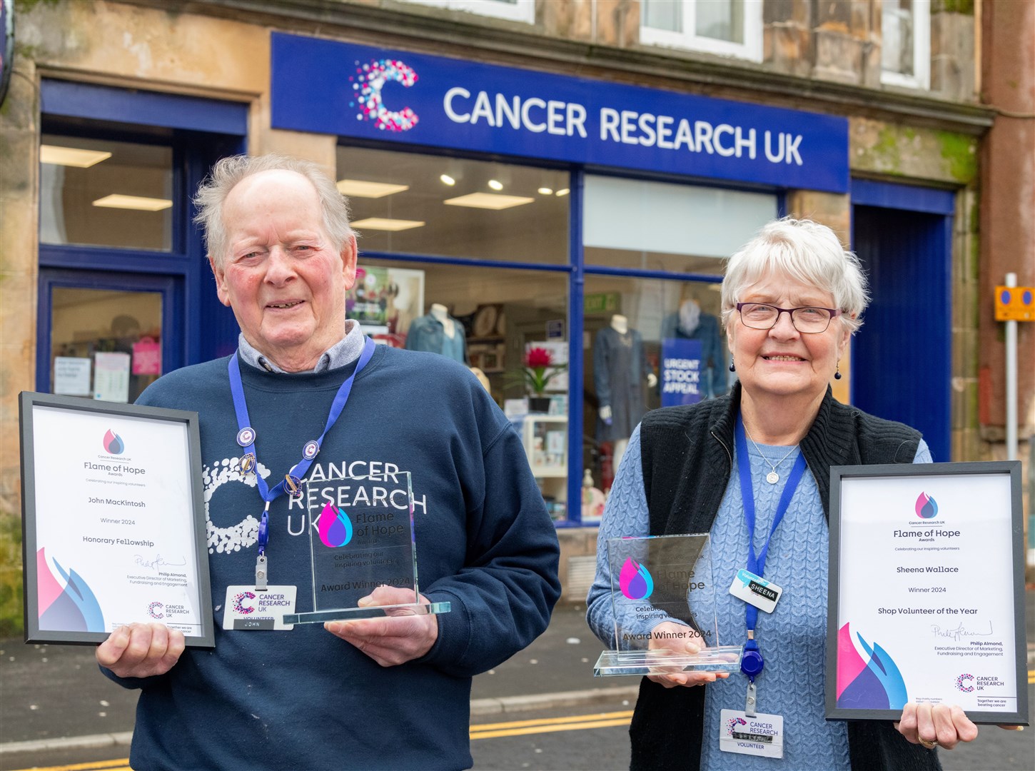 John MacKintosh and Sheena Wallace outside the Cancer Research UK Shop in Elgin. Picture: Beth Taylor