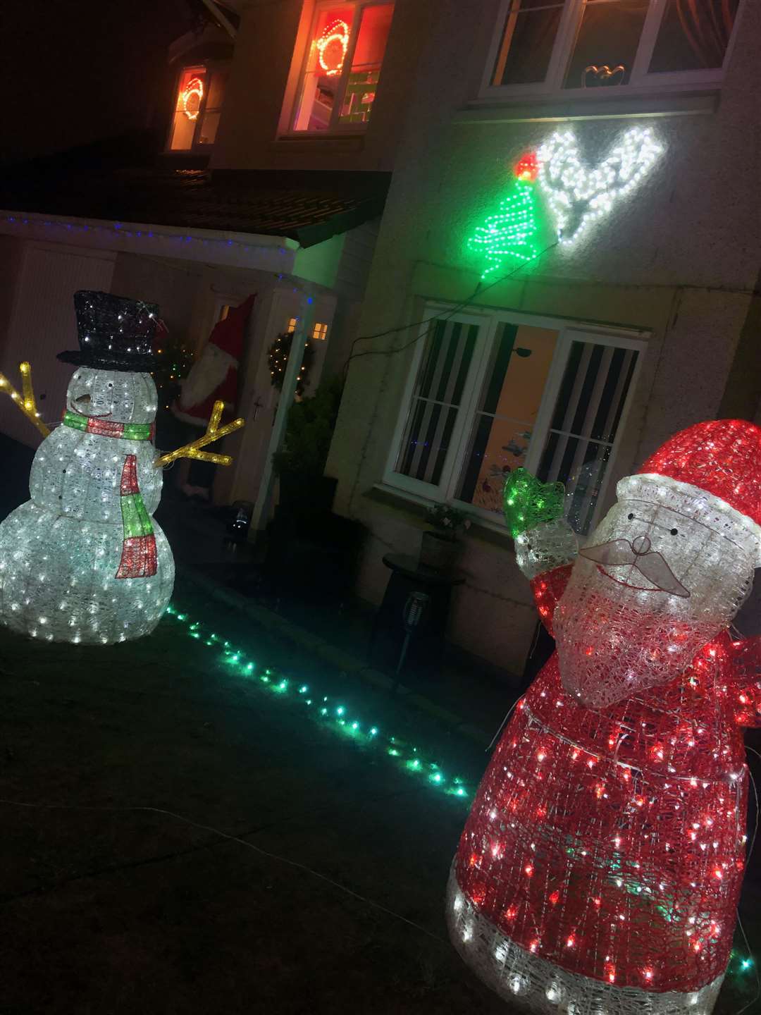 A warm welcome from an illuminated snowman and santa.
