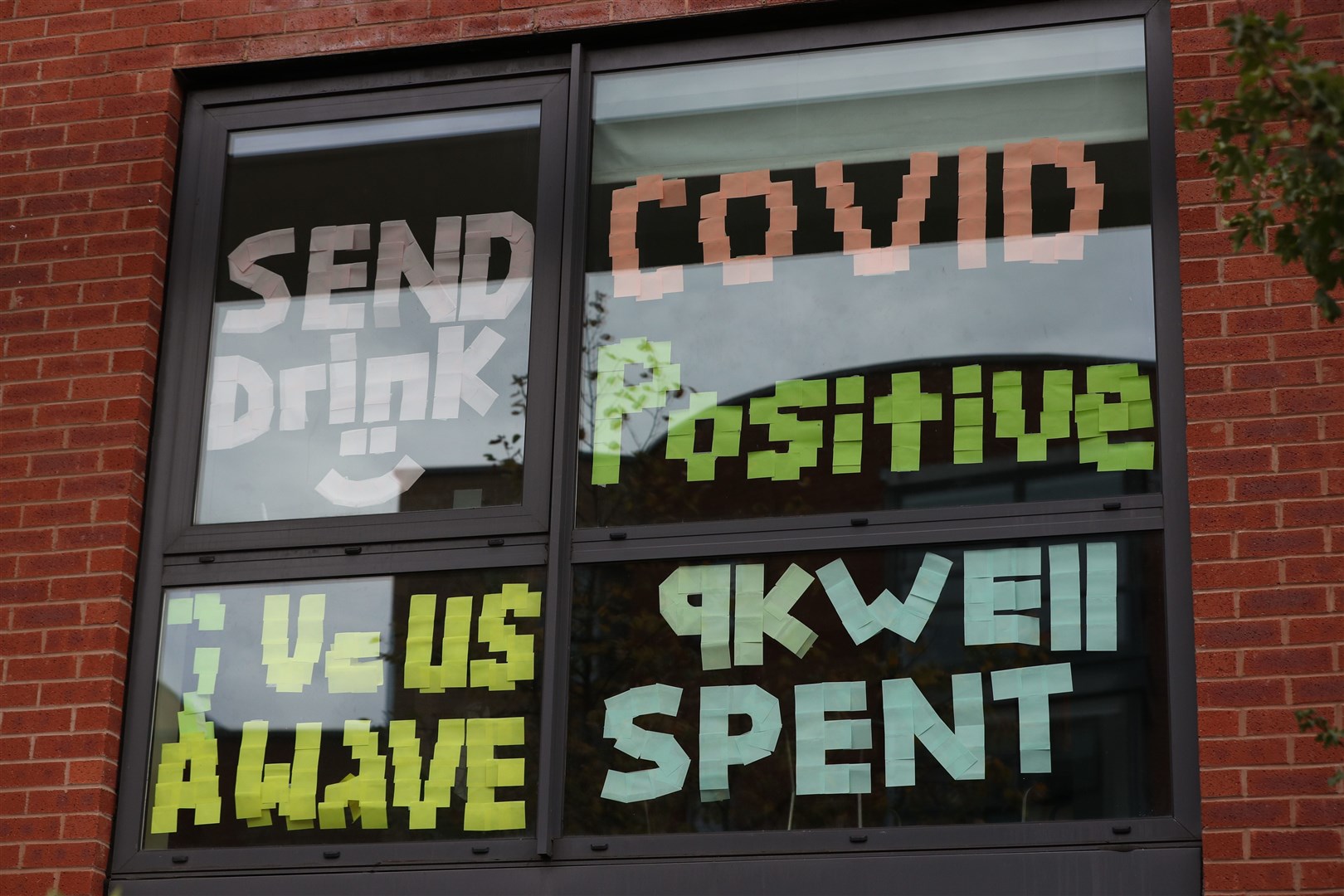 Signs on a window at Manchester Metropolitan University’s Birley campus where hundreds of students have been told to self-isolate (Peter Byrne/PA)
