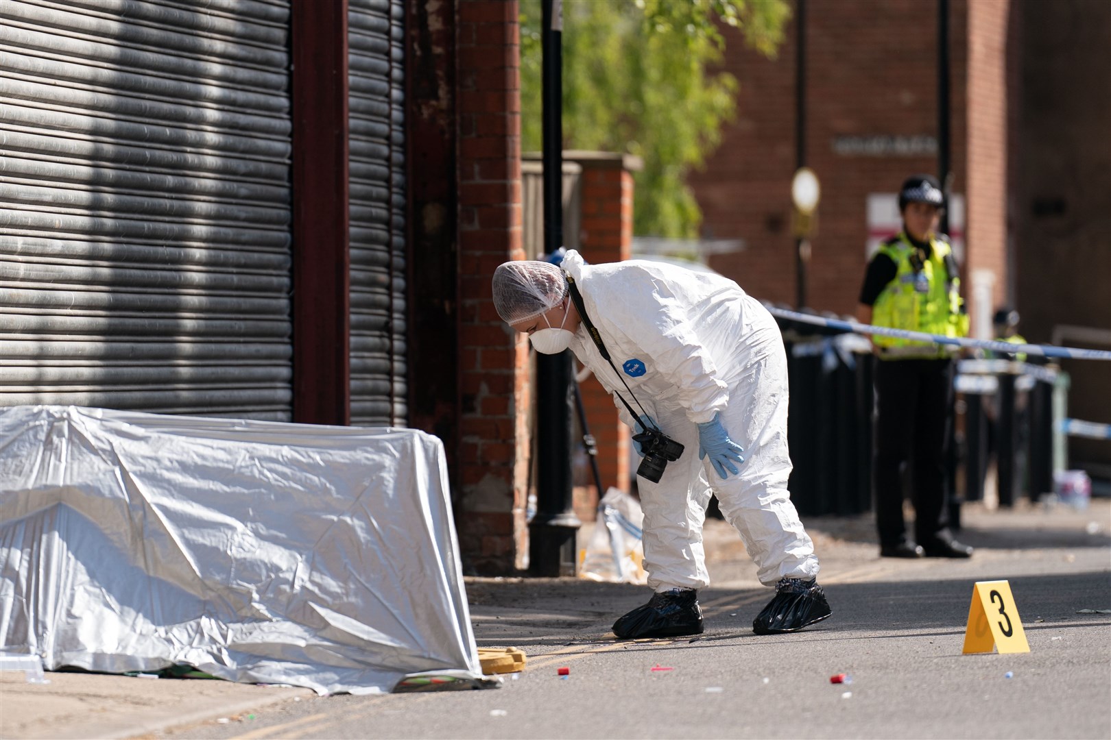 A forensic officer near the scene of the stabbing in Boston (Joe Giddens/PA)