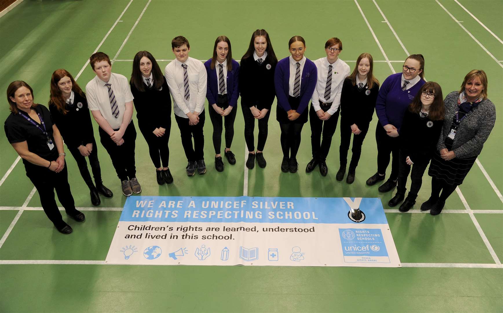 Speyside High receives a Silver Rights Respecting School Award from UNICEF. Proudly displaying the banner are members of the school's Rights Group with co-ordinator Imogen Nairn (left) and head teacher Patricia Goodbrand (right). Picture: Eric Cormack.