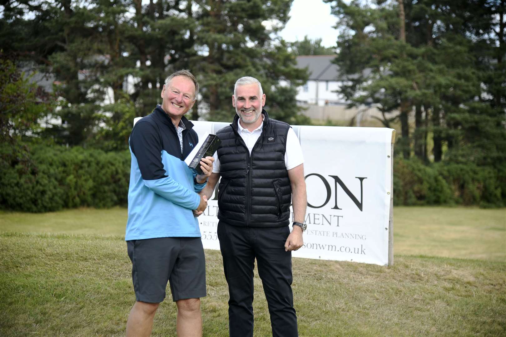 Ross Hardie being presented with a bottle of whisky by Martin Grierson...Elgin Five Day Open 2022...Picture: Beth Taylor.