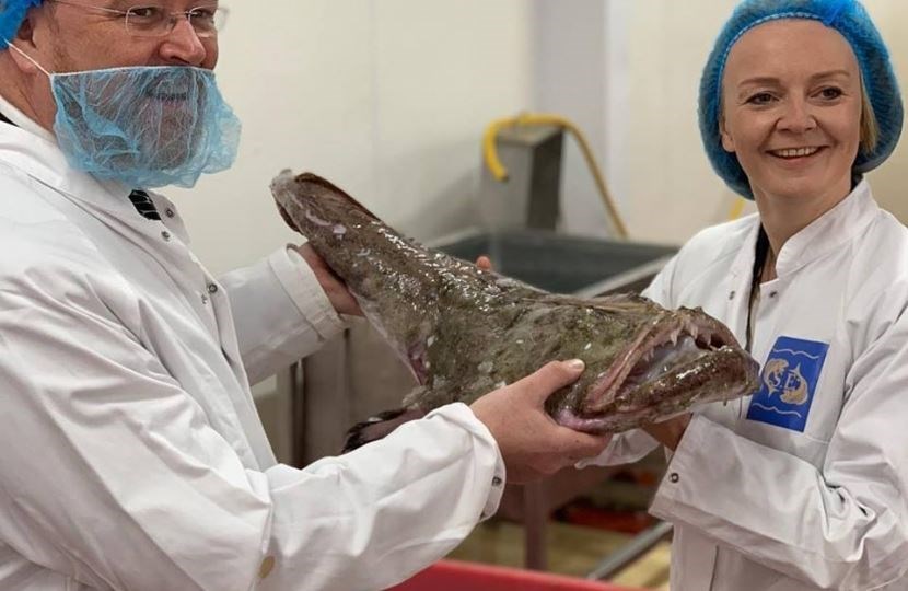 Liz Truss MP (right) with David Duguid MP during a visit to the fish market at Peterhead.