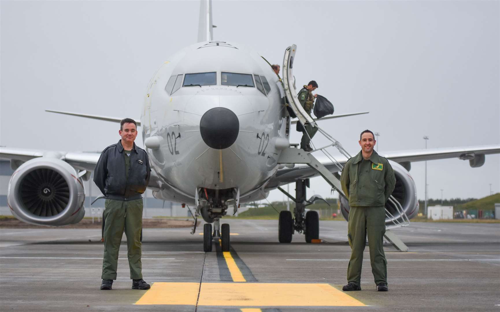 Group Captain Chris Layden (left) and Wing Commander James Hanson welcome the first Poseidon to RAF Lossiemouth. Picture: Becky Saunderson.