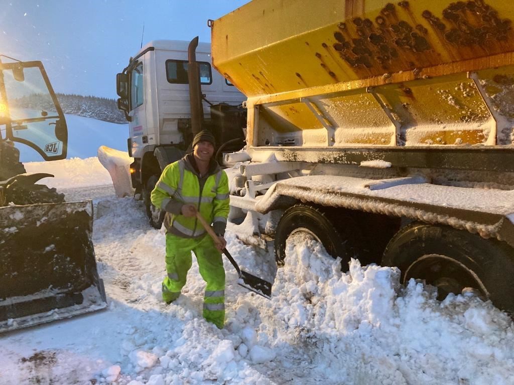 Alex Smith clearing his digger wheels ahead of an evening shift in the Lecht.