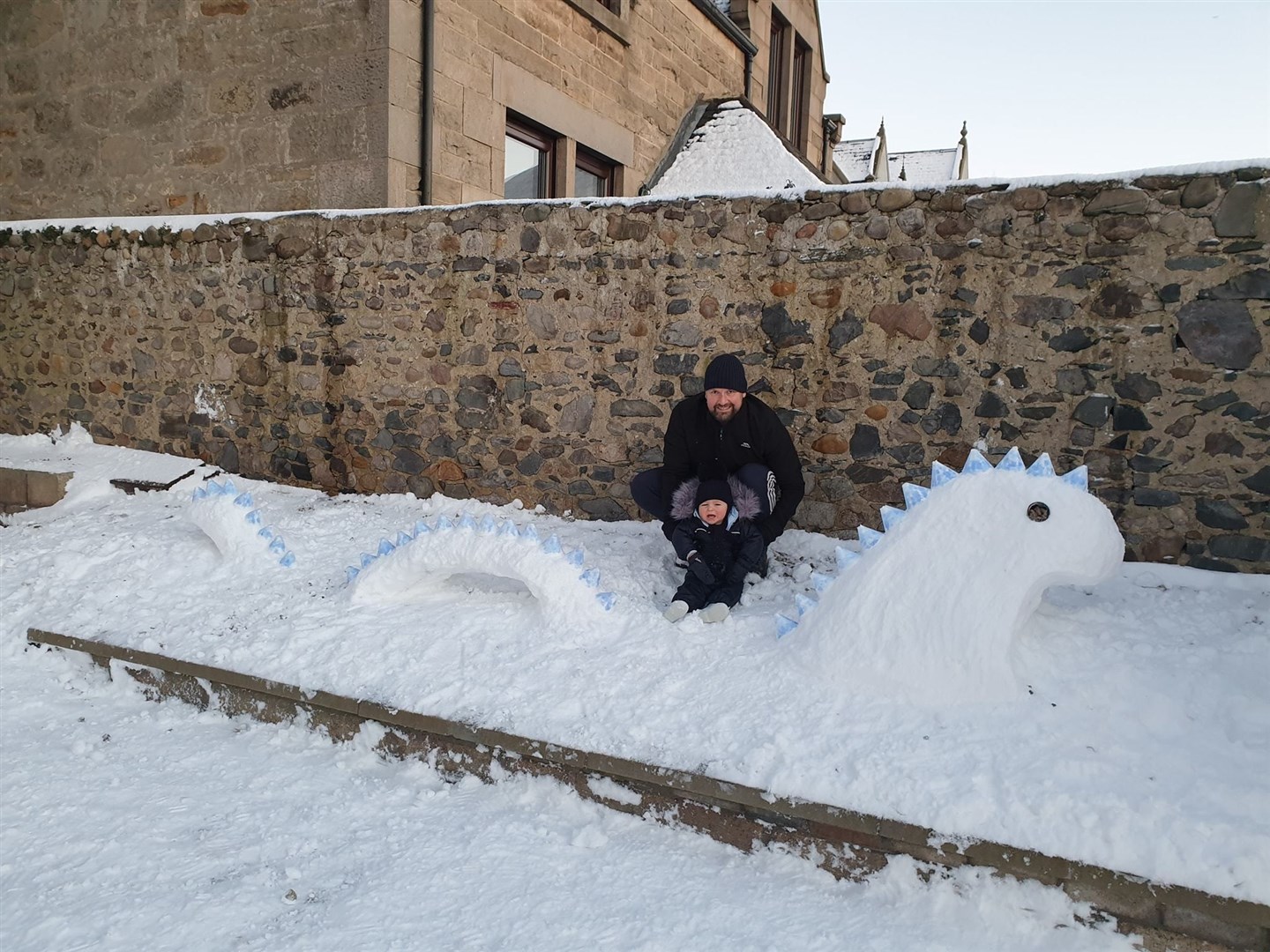 Dad Lee and son Liam enjoying the youngster's first year in the snow by building this Loch Ness monster in Buckie. Picture: Stephanie Costello
