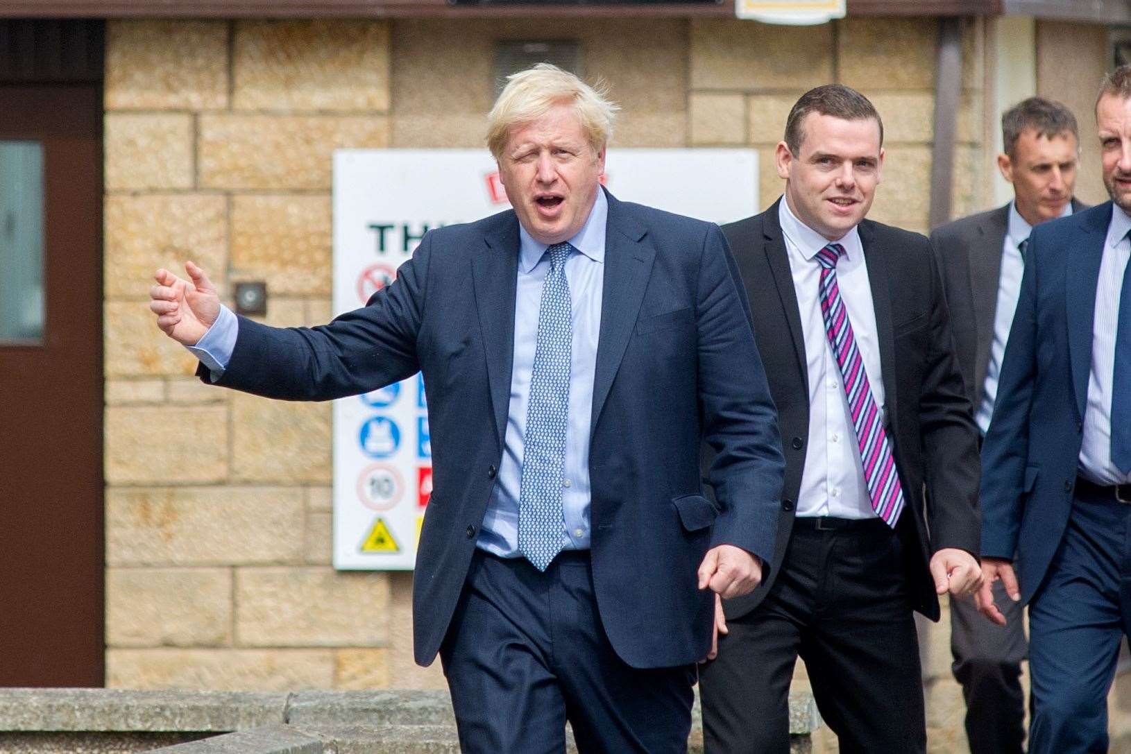 Douglas Ross has called for Prime Minister Boris Johnson (front) to resign off the back of admitting he attended a party at 10 Downing Street.