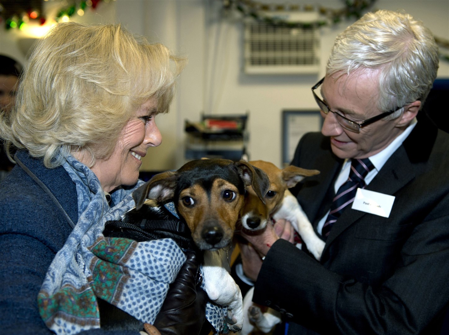Camilla with Paul O’Grady while holding her two adopted dogs Bluebell and Beth in 2012 (Adrian Dennis/PA)