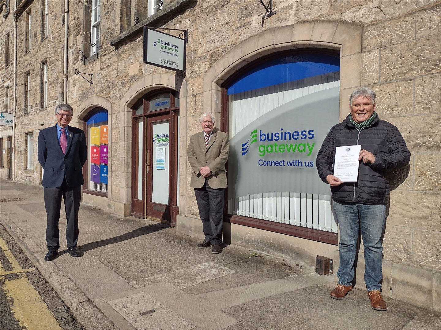 Lord Lieutenant of Banffshire Andrew Simpson (l) and Lord Lieutant of Moray Seymour Monro present a letter of commendation to Craig Robertson (r) of Business Gateway.