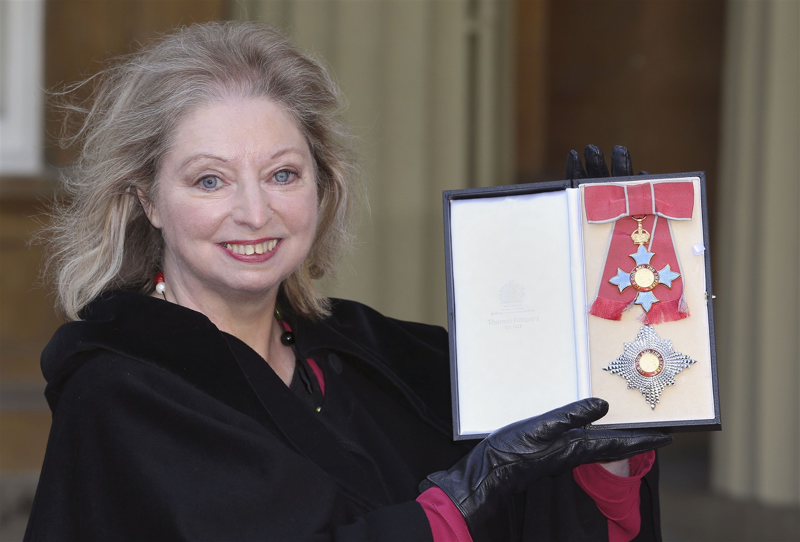 Dame Hilary Mantel holding her Dame Commander of the British Empire medal presented to her for services to literature (Philip Toscano/PA)