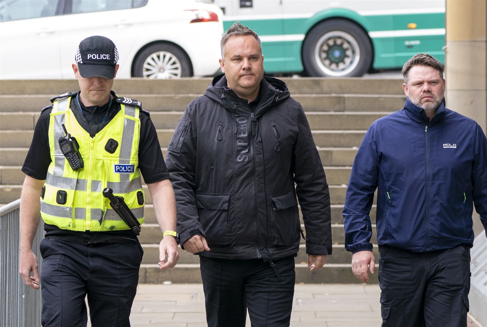 Sergeant Scott Maxwell (centre) arrives at Capital House in Edinburgh for the public inquiry into Sheku Bayoh’s death. Bayoh died in May 2015 after he was restrained by officers responding to a call in Kirkcaldy, Fife (Jane Barlow/PA)