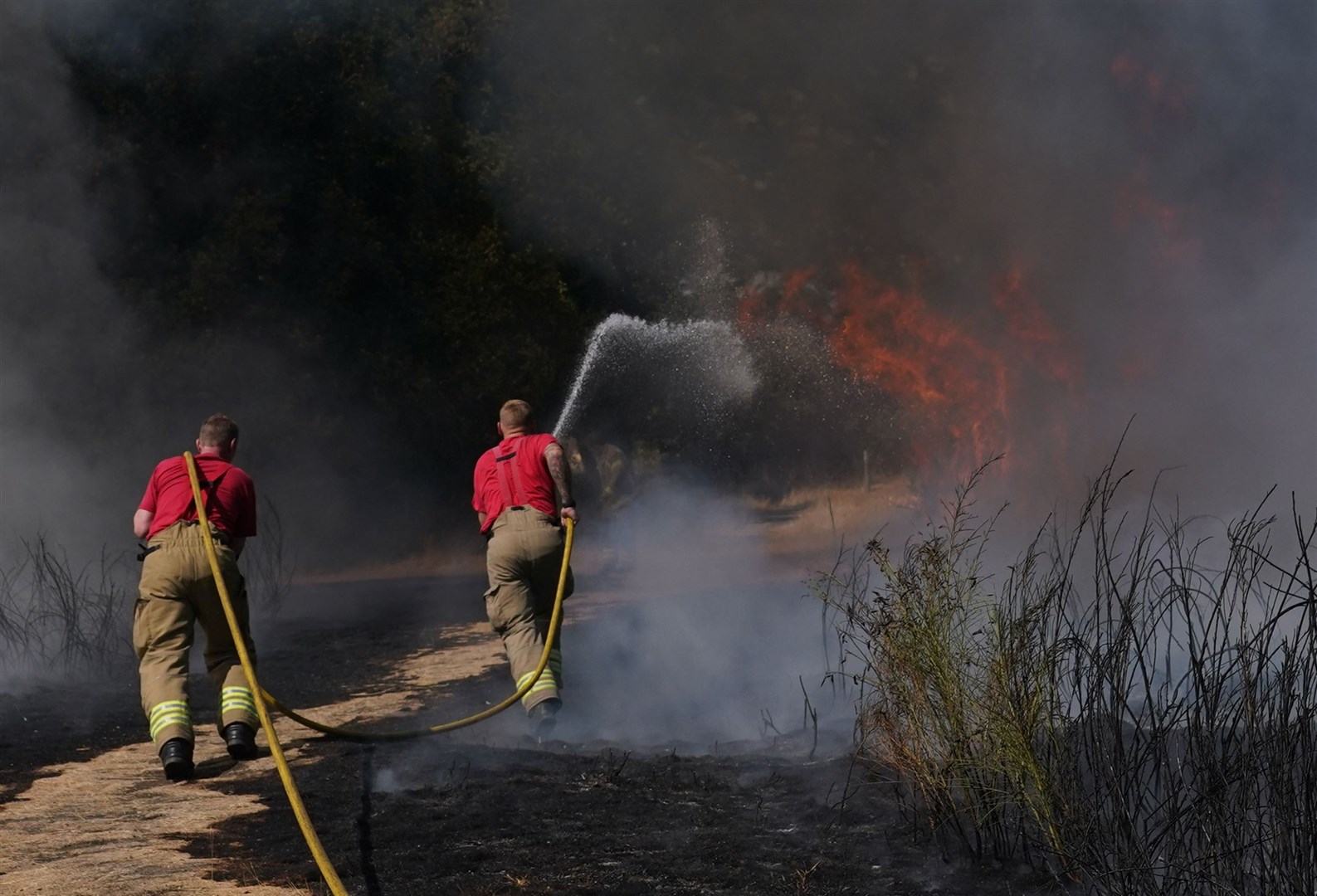 Firefighters battle a grass fire at Leyton Flats (Yui Mok/PA)
