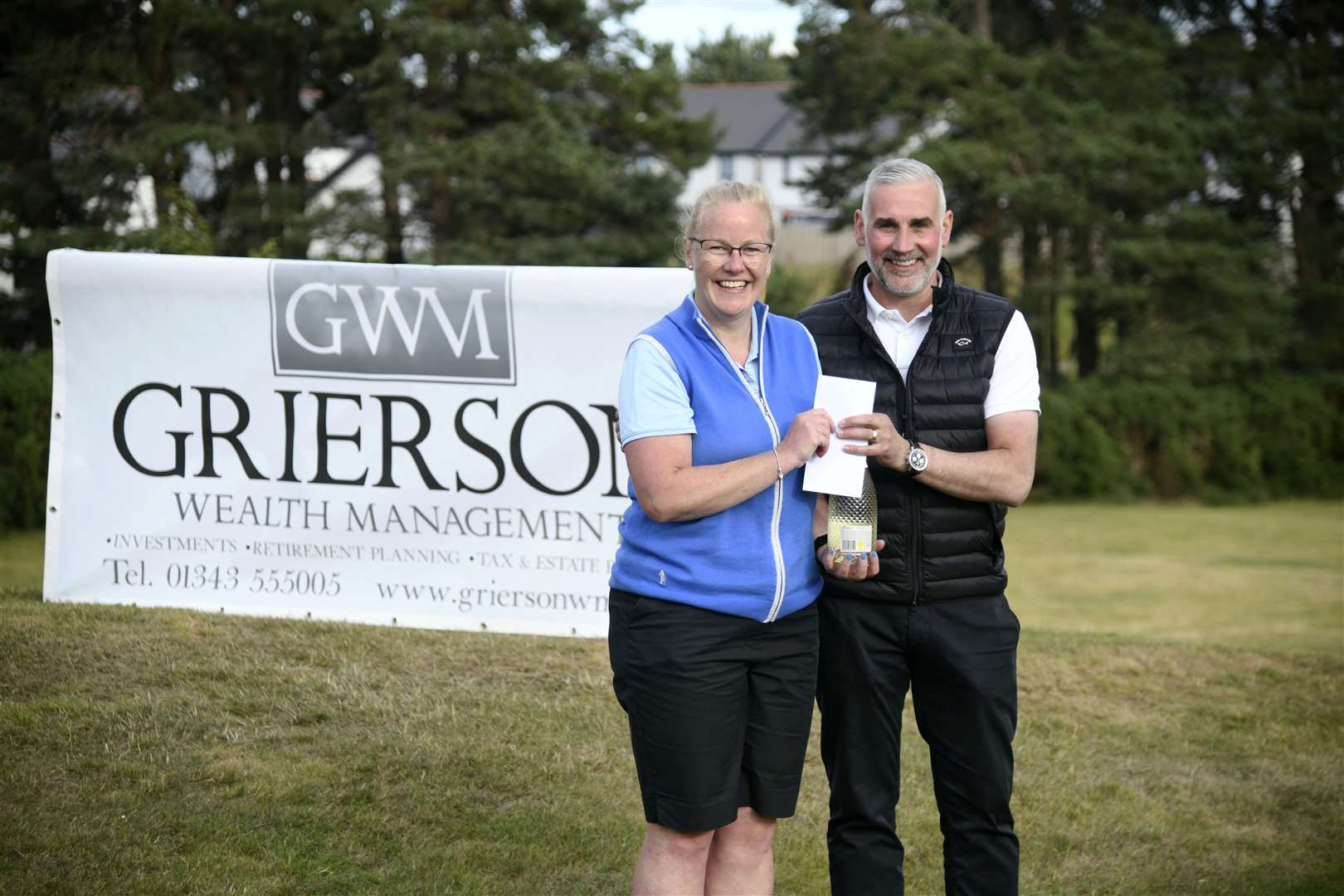 Louise Marshall being presented with a bottle of prosecco by Martin Grierson...Elgin Five Day Open 2022...Picture: Beth Taylor.
