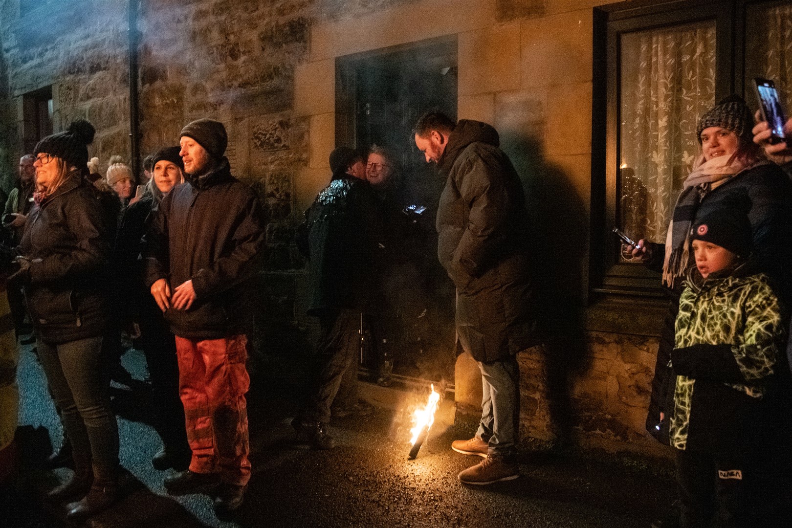 Members of the Clavie crew with hand out burning staves to Brochers.. Picture: Daniel Forsyth