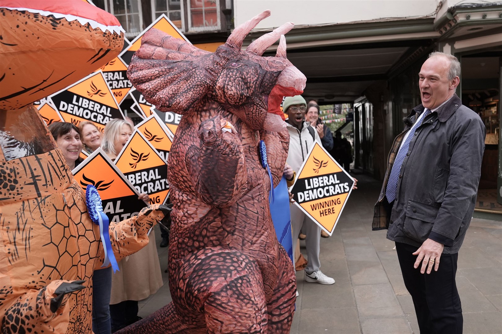 Liberal Democrat leader Sir Ed Davey is greeted by Tory ‘dinosaurs’ as he arrives to join local Lib Dem campaigners at a celebratory rally in Winchester following the local government elections (Stefan Rousseau/PA)