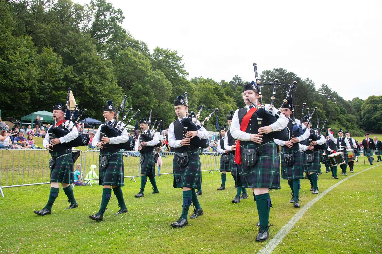 The Forres and District Pipe Band march around the games arena in Grant Park before the offical opening of the games...Forres Highland Games 2022...Picture: Daniel Forsyth..