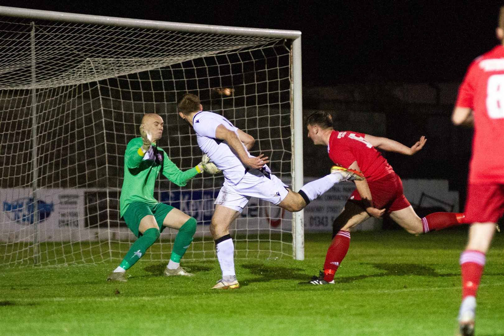 Lossiemouth keeper Logan Ross saves another headed effort - this time from Rothes' Gary Kerr.