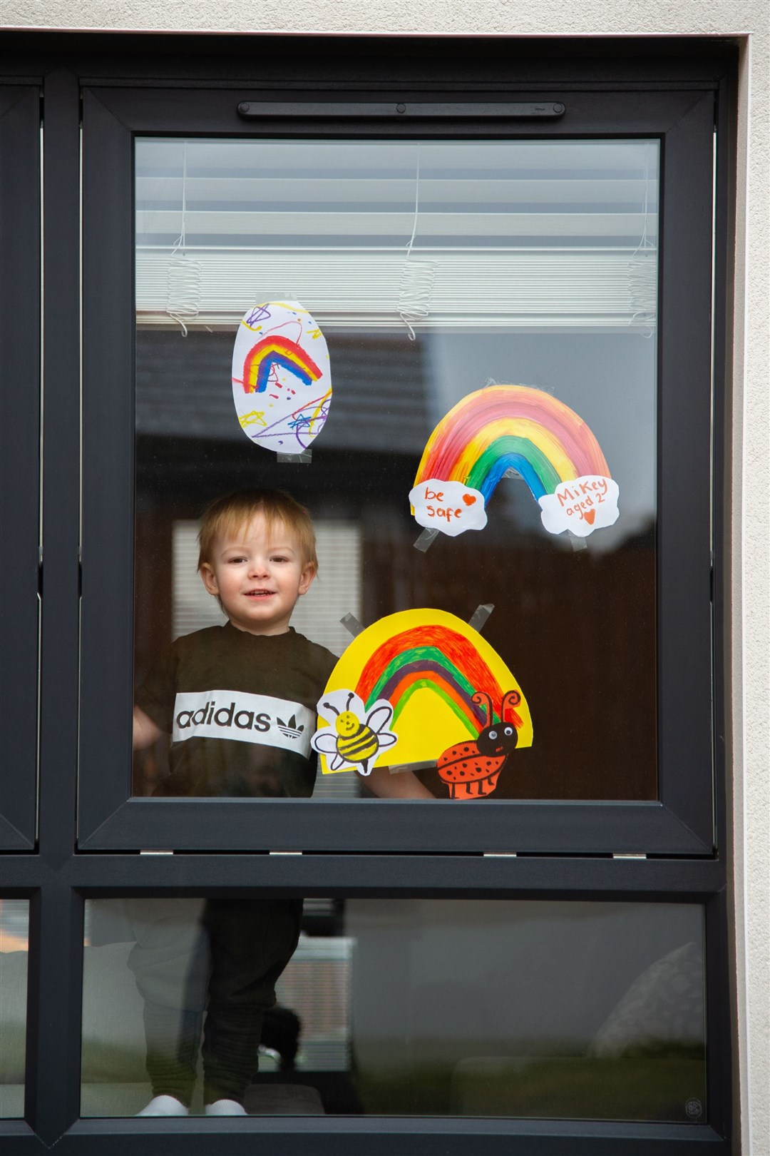 Mikey Gordon alongside his rainbow display in Elgin. Picture: Daniel Forsyth.