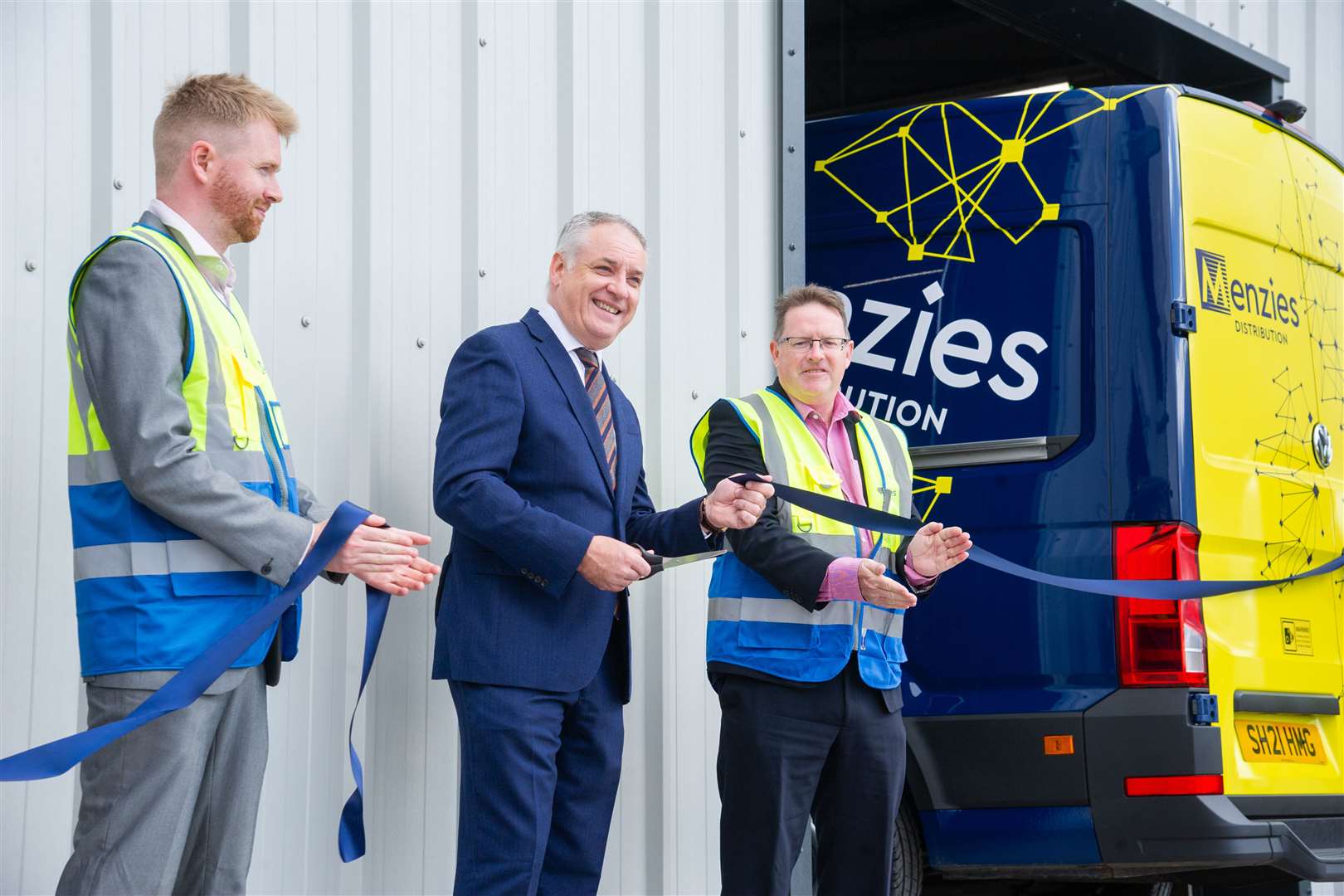 Moray MSP Richard Lochhead is joined by Menzies operations manager Stephen Cameron (left) and parcels operations director Stephen Mooney (right) for the ribbon-cutting ceremony to open Menzies Distribution centre in Elgin. Picture: Daniel Forsyth.
