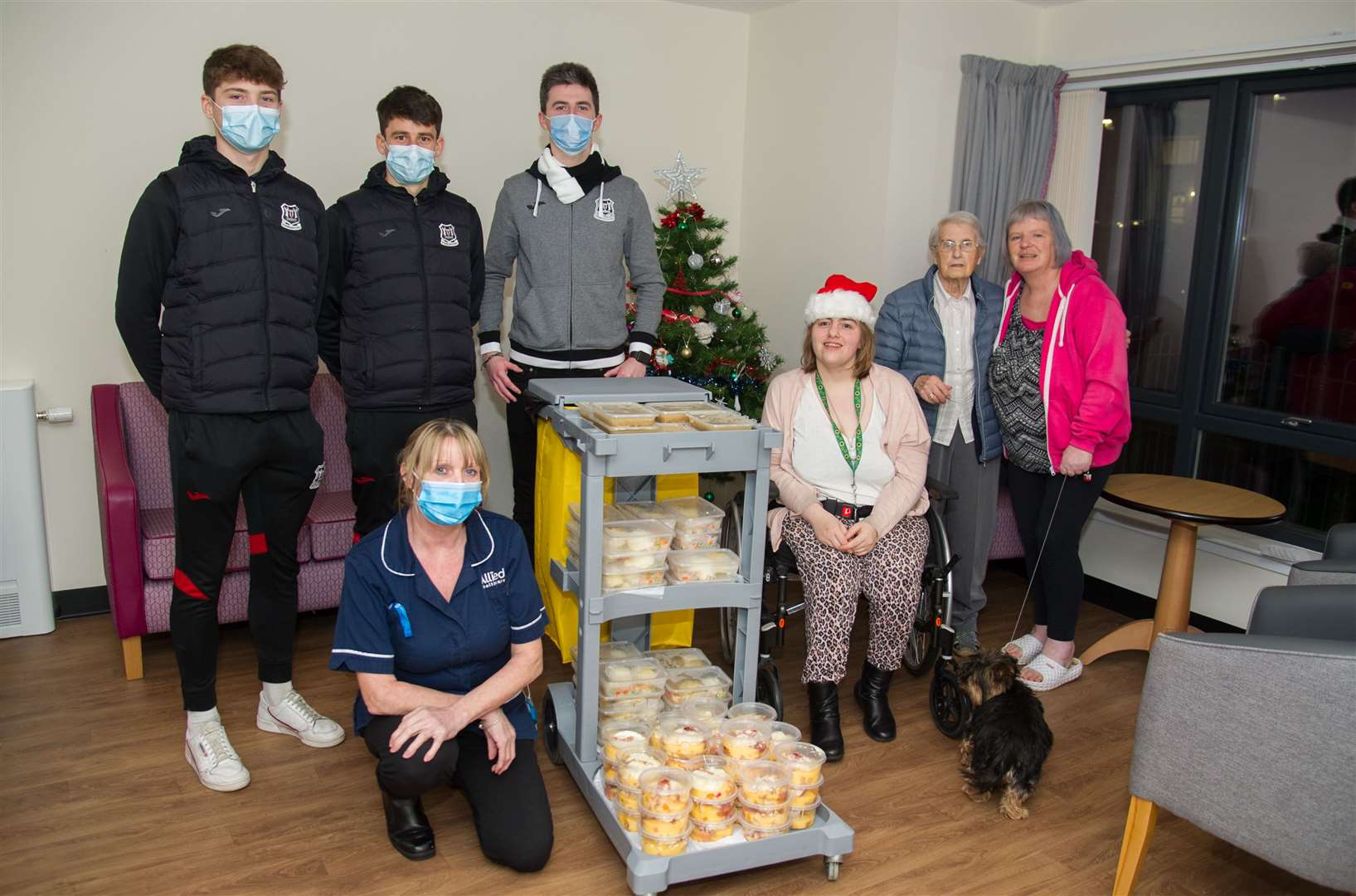 From left Fin Allen, Rory McEwan and Keiran Carty from Elgin City with Anne, Cherry and Pauline from Loxa Court with Team Leader Joanne (front). Picture: Becky Saunderson