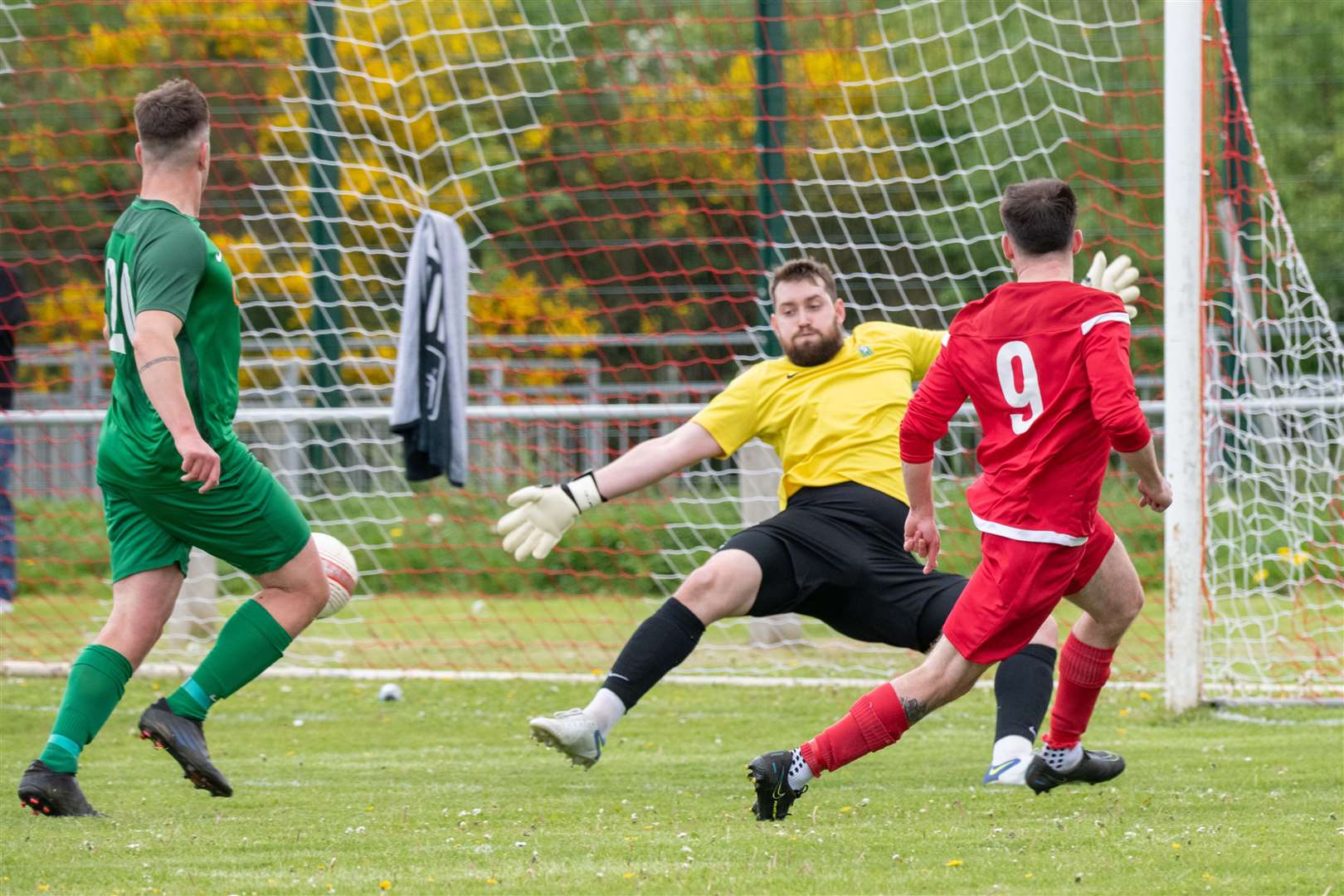 Forres Thistle's Matthew Fraser scores past Dufftown goalkeeper Stewart Black to make it 1-1 in the first half...Dufftown FC (2) vs Forres Thistle FC (2) - Dufftown FC win 5-3 on penalties - Elginshire Cup Final held at Logie Park, Forres 14/05/2022...Picture: Daniel Forsyth..