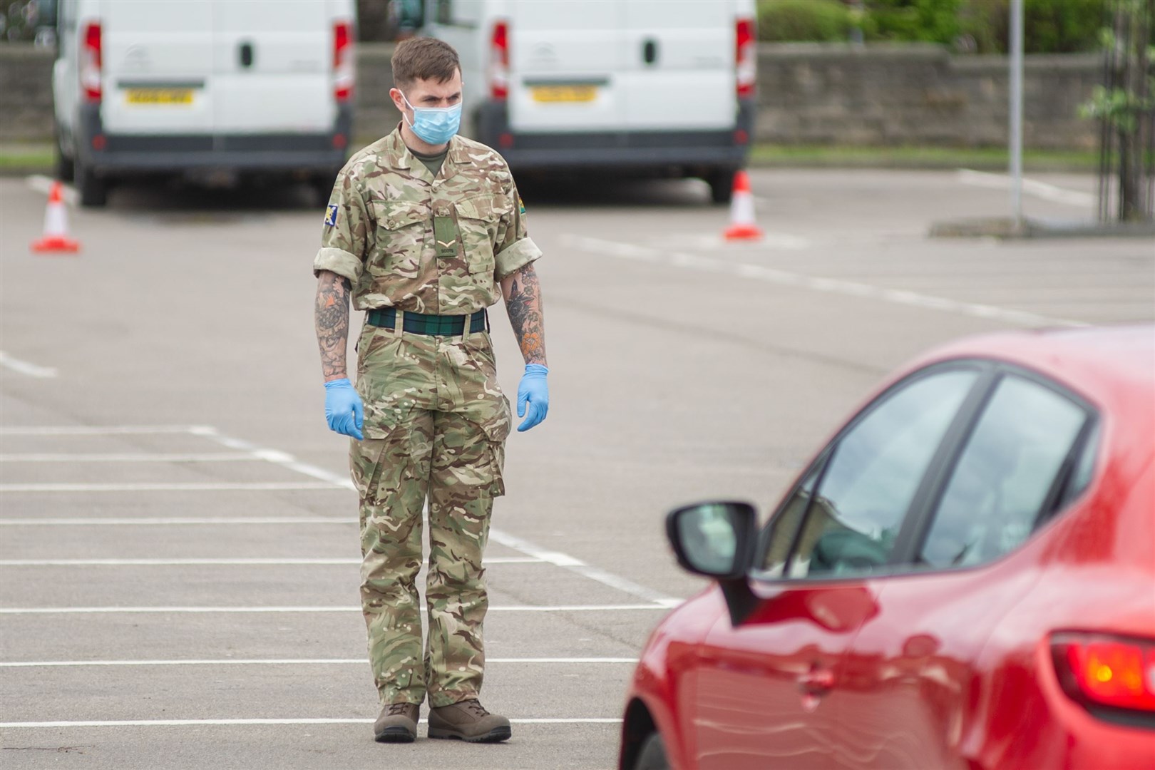 A member of the armed forces guides a motorist through the testing centre. Picture: Daniel Forsyth