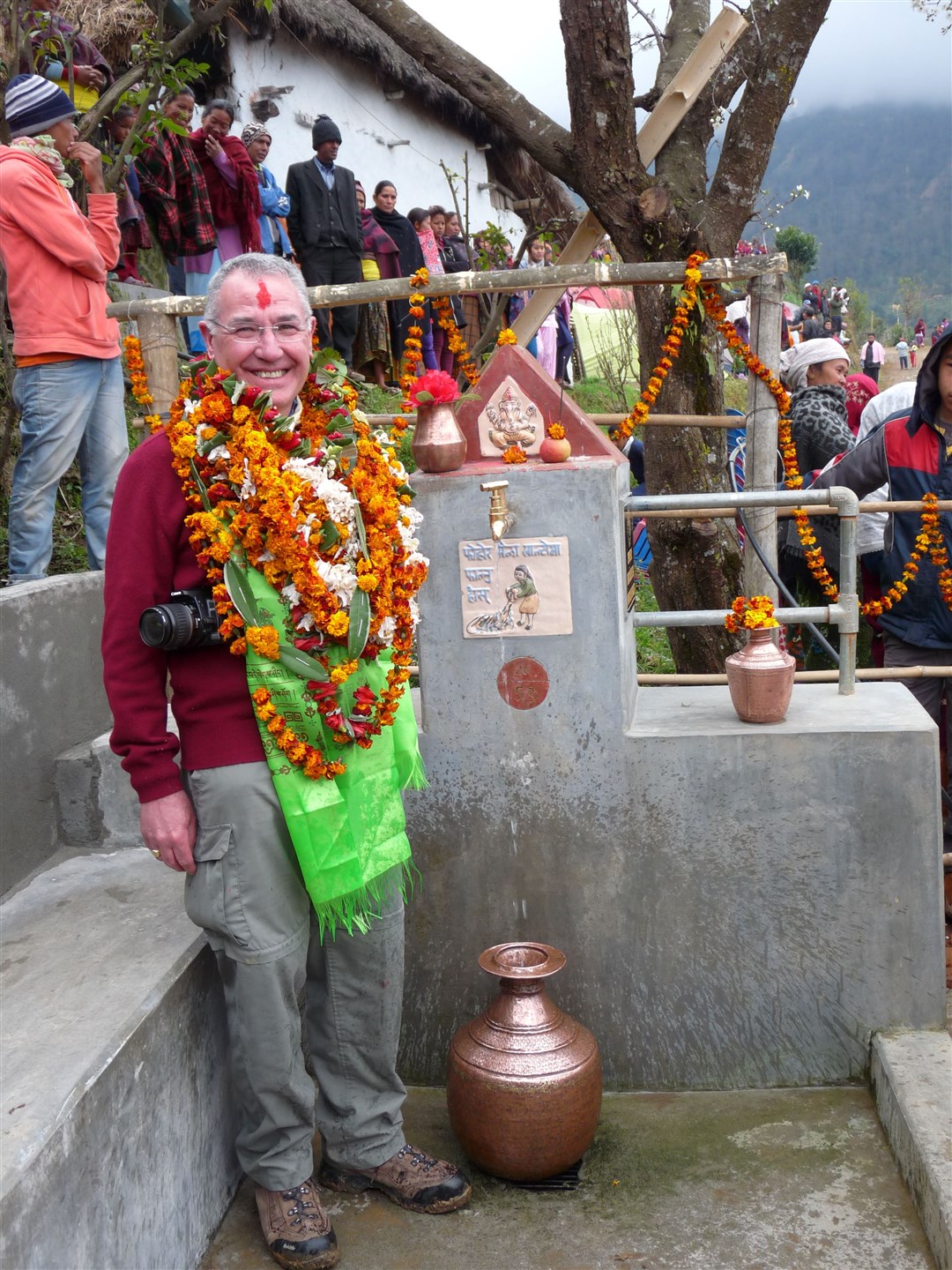 Past President Bill Ross with a celebratory water tap in Kades, Nepal in 2014.