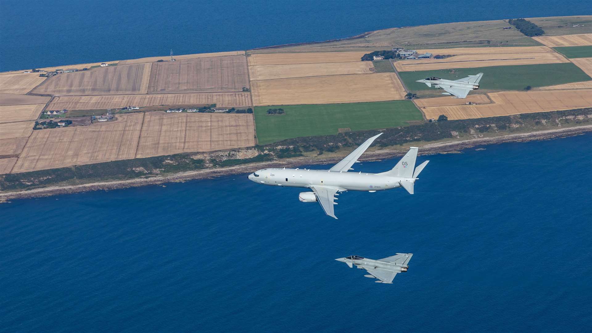 P-8A Poseidon with two Typhoons over RAF Lossiemouth.